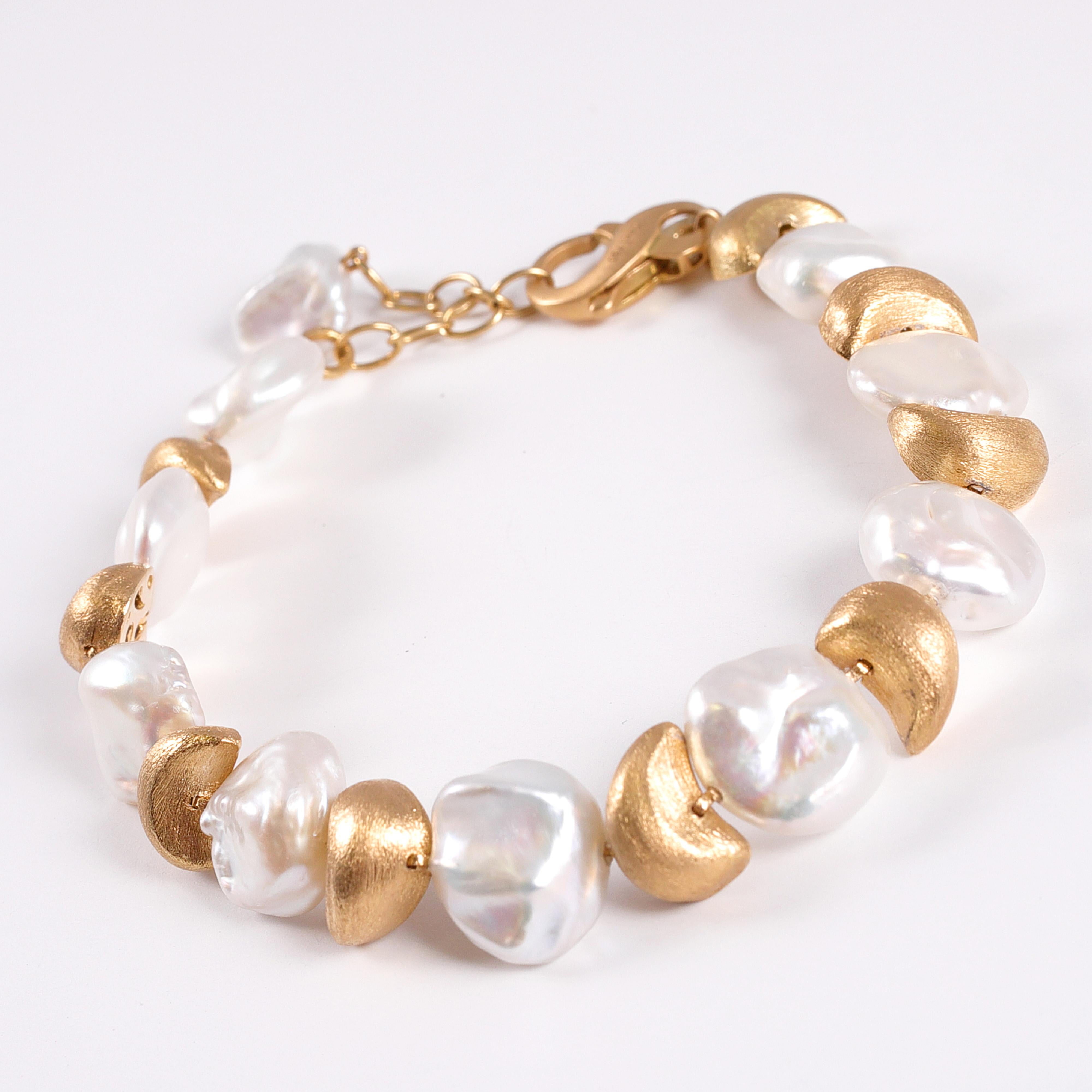 Bracelet featuring baroque pearls with 18 Karat Gold crescents by Yvel.  The pearls average 10.5 to 11.5 millimeters.  The bracelet is adjustable in length from 7 to 8 inches and comes with the original box.