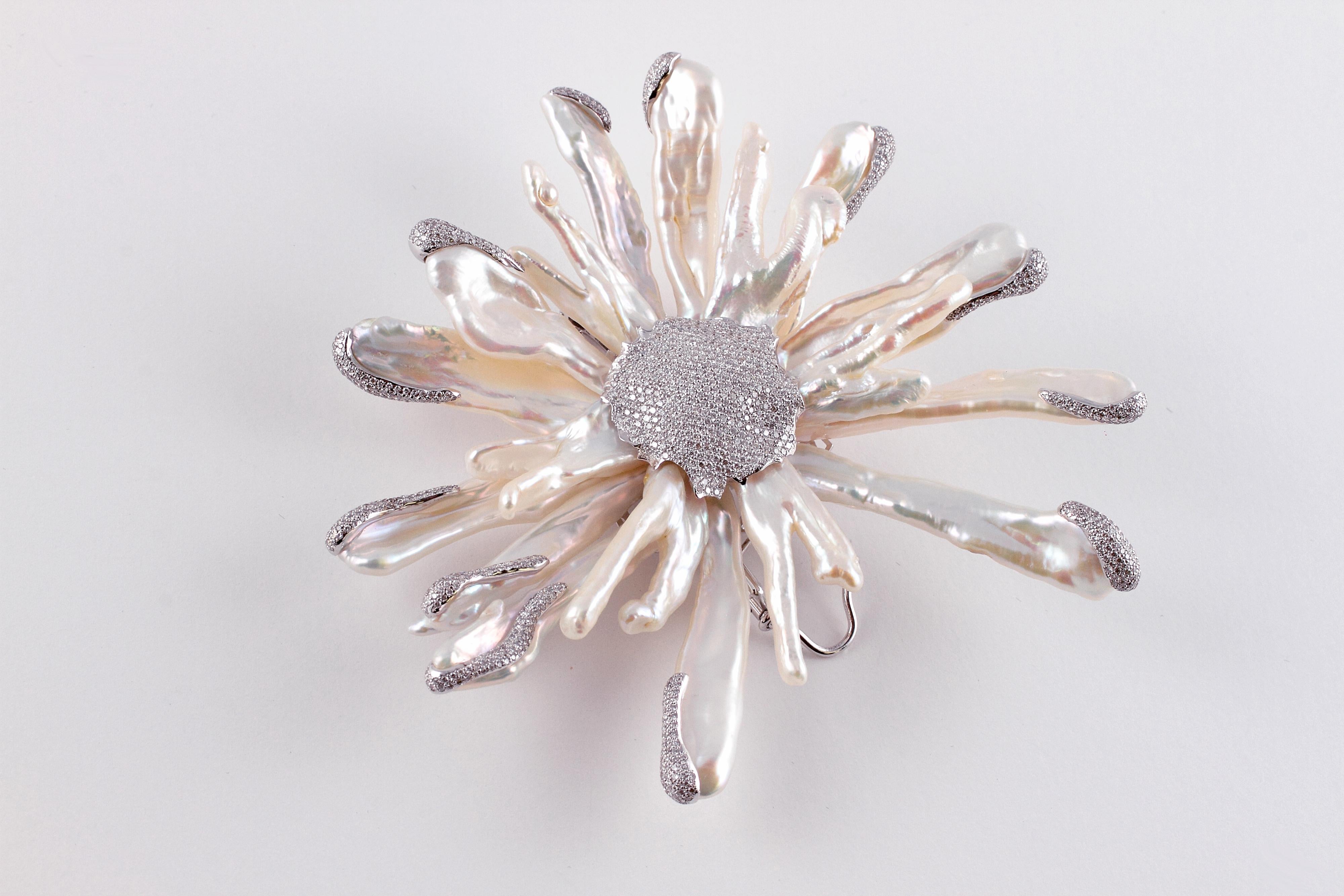 A striking 18 Karat White Gold Flower Brooch by Yvel of Israel with Keshi Pearls and set with 5.72 carats of diamonds.  The pearls have a white body color, excellent to moderate luster, and range from approximately 20 mm to 50 mm in length.  The
