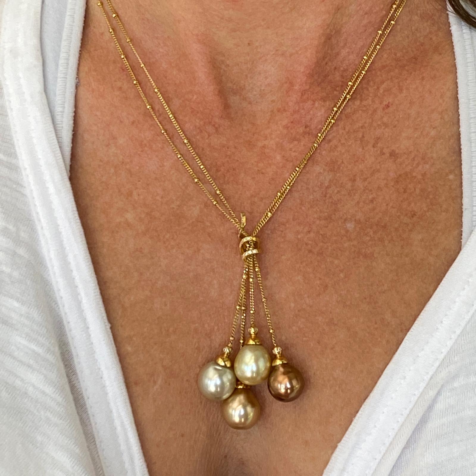 Beautiful South Sea pearl and diamond drop necklace, by designer Yvel,  fashioned in 18 karat yellow gold. The necklace features 4 multi-color baroque South Sea pearls measuring 11.2-12.1mm, and 23 round brilliant cut diamonds weighing .18 CTW