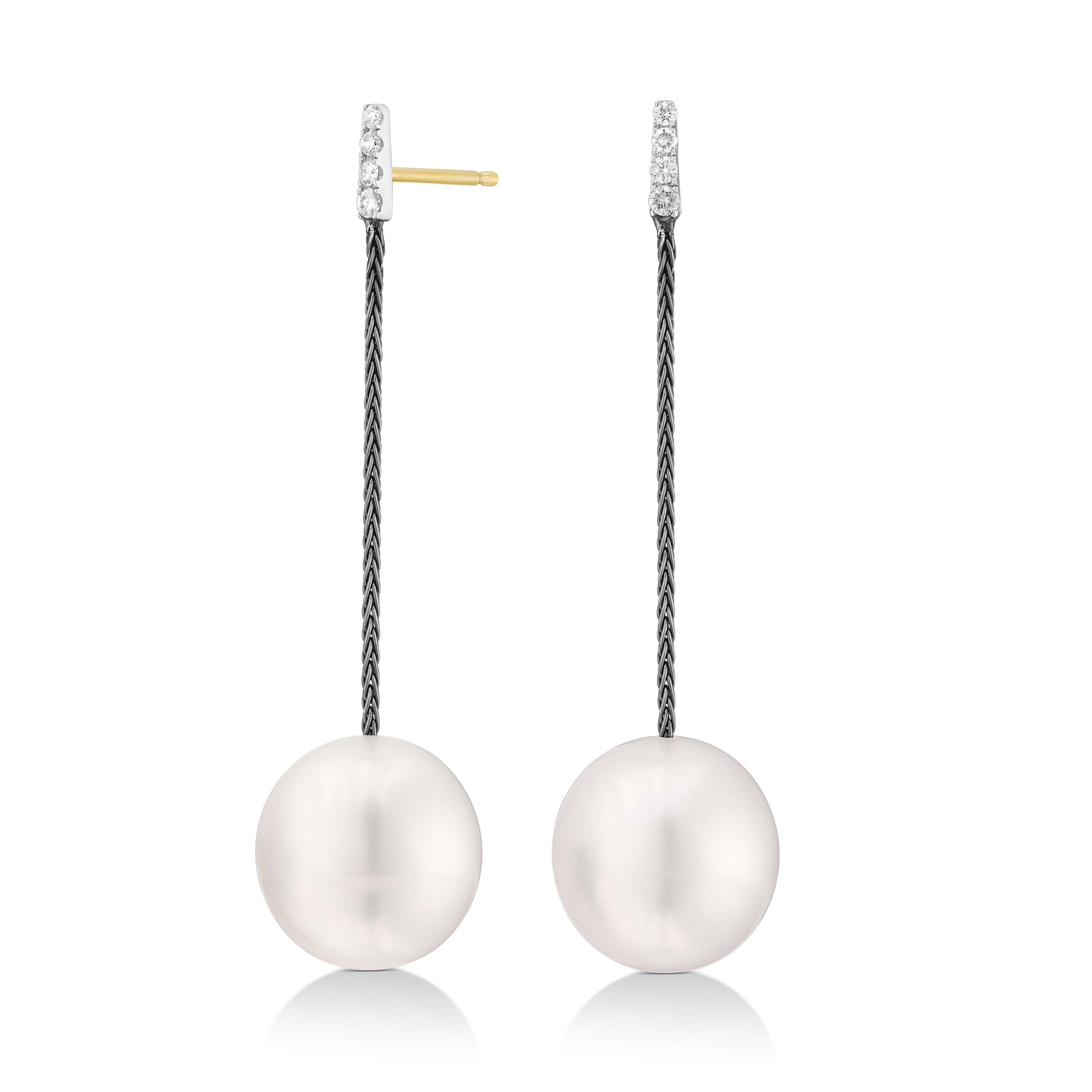 The Black & White Collection elegantly redefines modernity with these South Sea Pearl Drop Earrings. Suspended from a thread of 18K black gold, each earring is anchored by a lustrous 13 x 14 mm South Sea pearl. The pearls' rich sheen is complemented