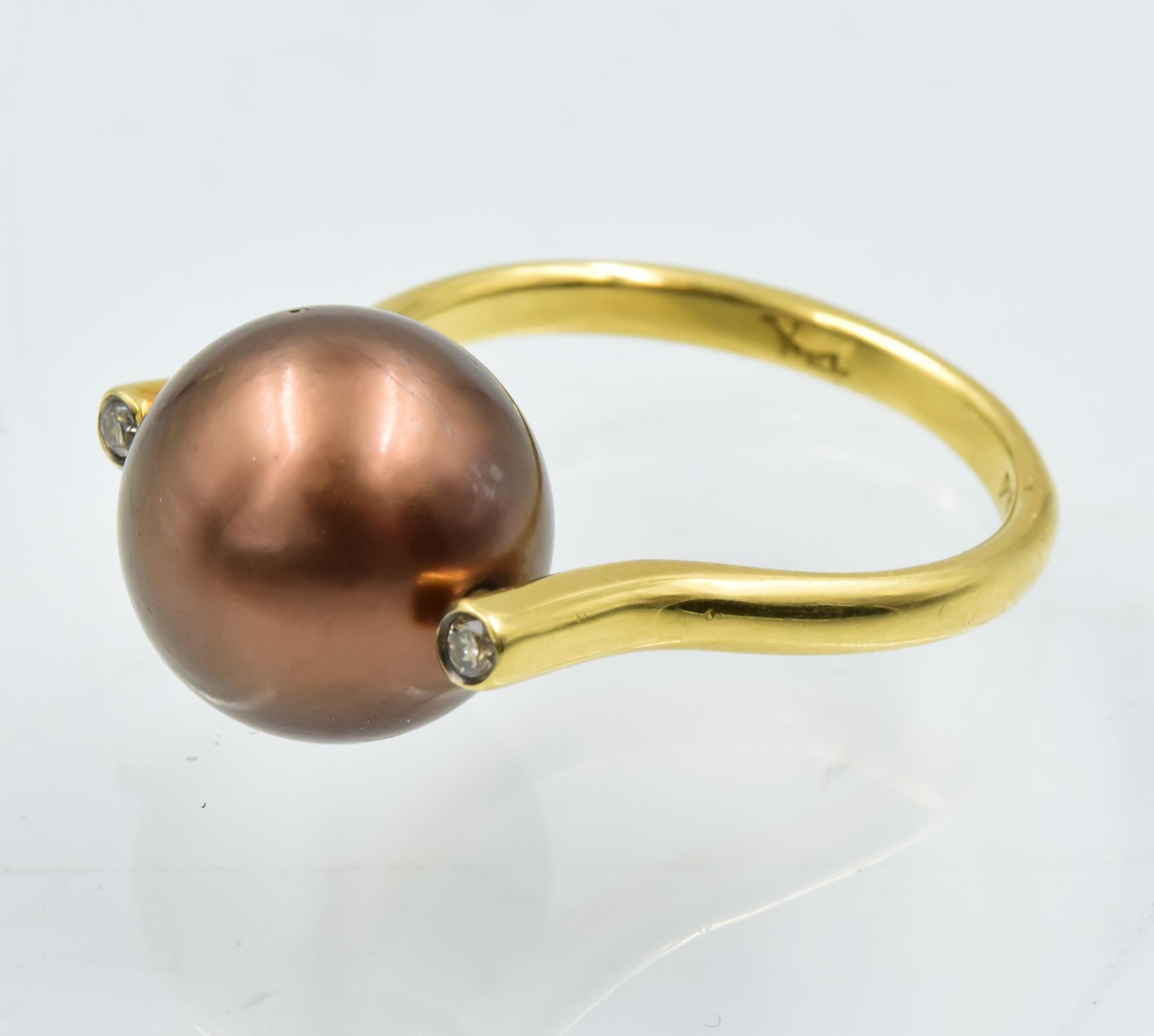This 18k yellow gold Yvel ring is a gorgeous ring with a chocolate pearl.  This ring is in excellent condition and was recently traded in to the store.  This ring can not be sized and is a size 5.25.  Please let us know if you have any further