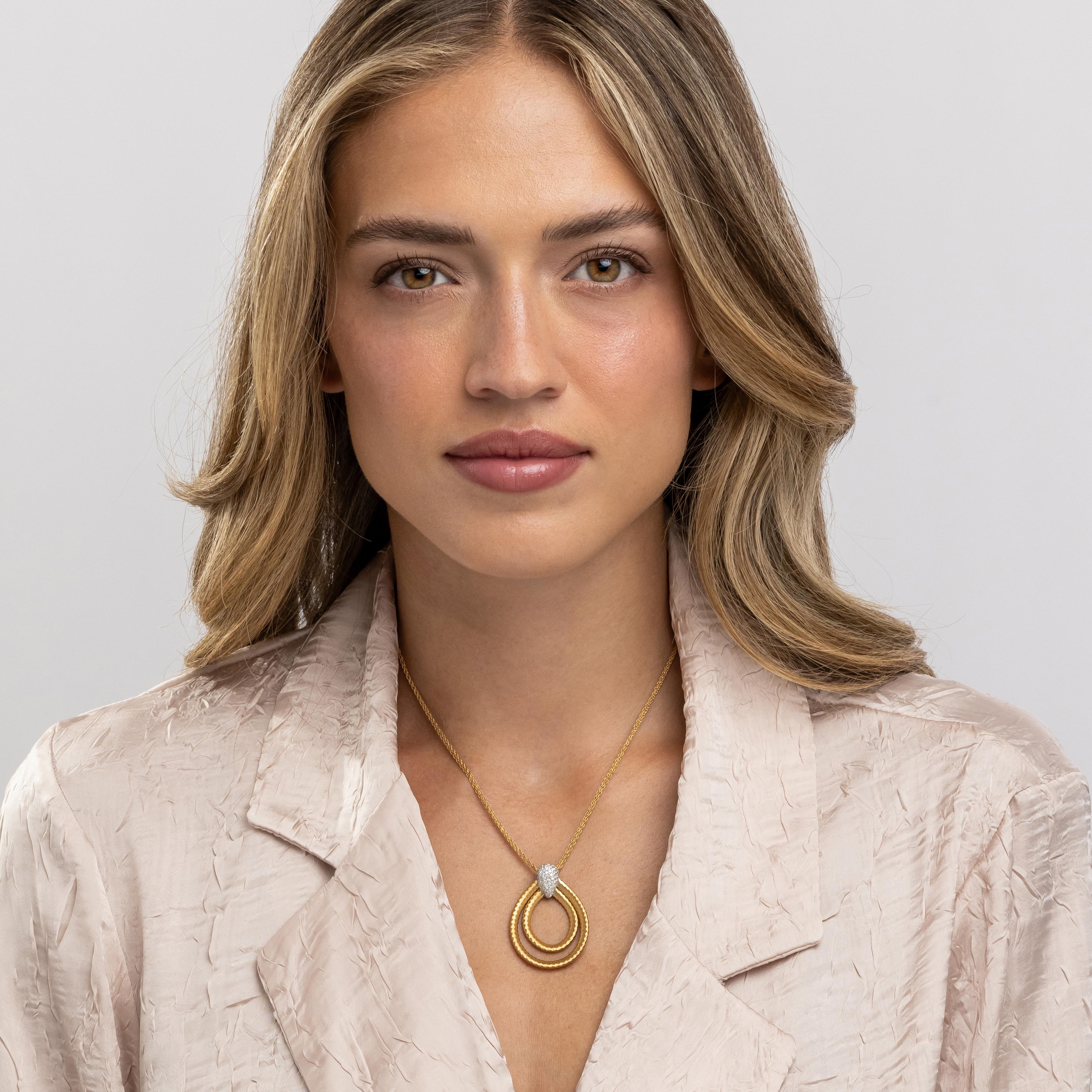 The Diamond Woven Pendant from Yvel’s Ethiopia Collection is a symbol of infinite artistry, combining the timeless allure of 18K yellow gold with the brilliance of 0.51 ct. of natural diamonds. This necklace features a duo of interlocking woven gold
