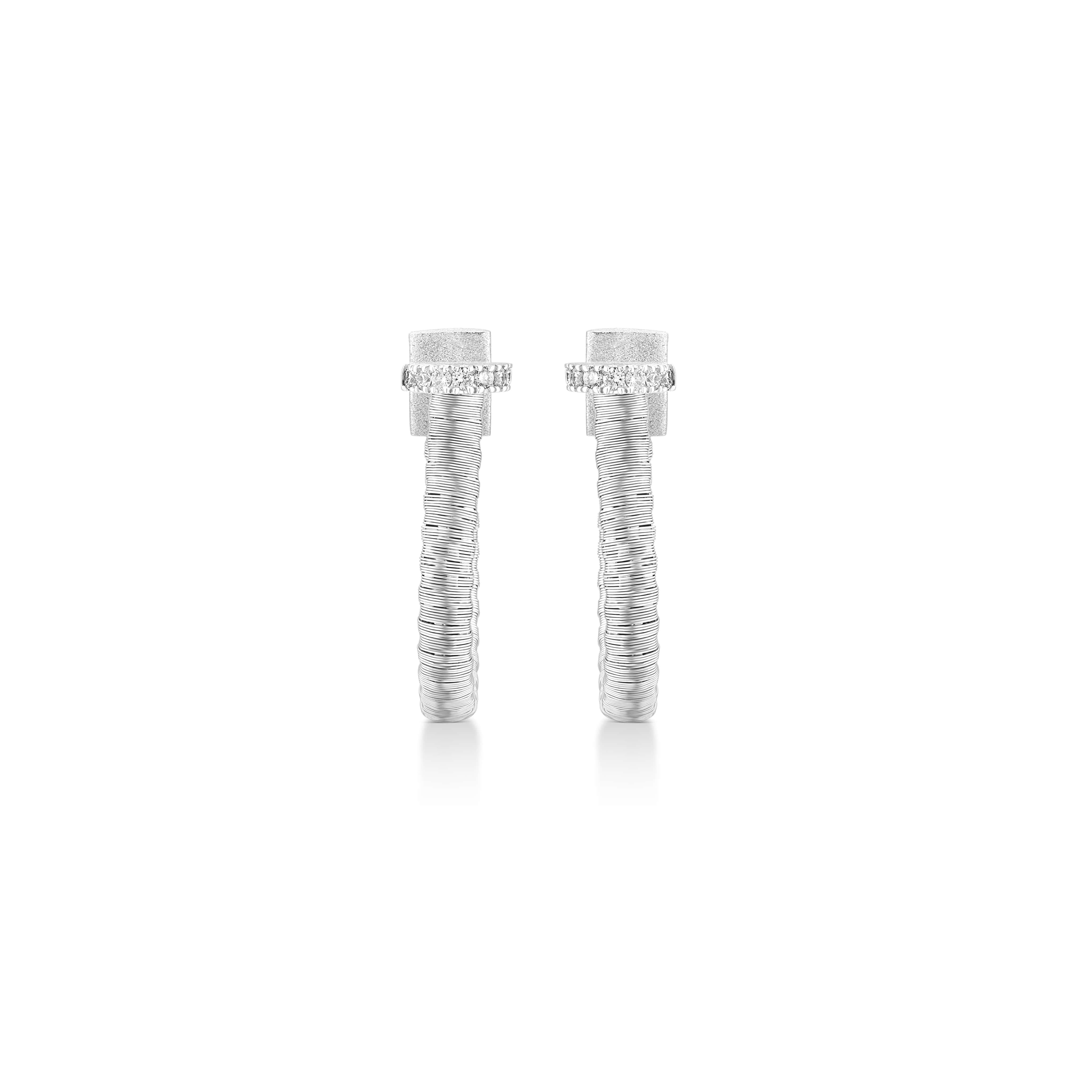 Part of Yvel’s Ethiopia Collection, these hoop earrings are crafted from 18k white gold, featuring a unique woven design inspired by the traditional textile techniques of Ethiopia. Each earring is set with 0.21 ct. of natural white diamonds that add