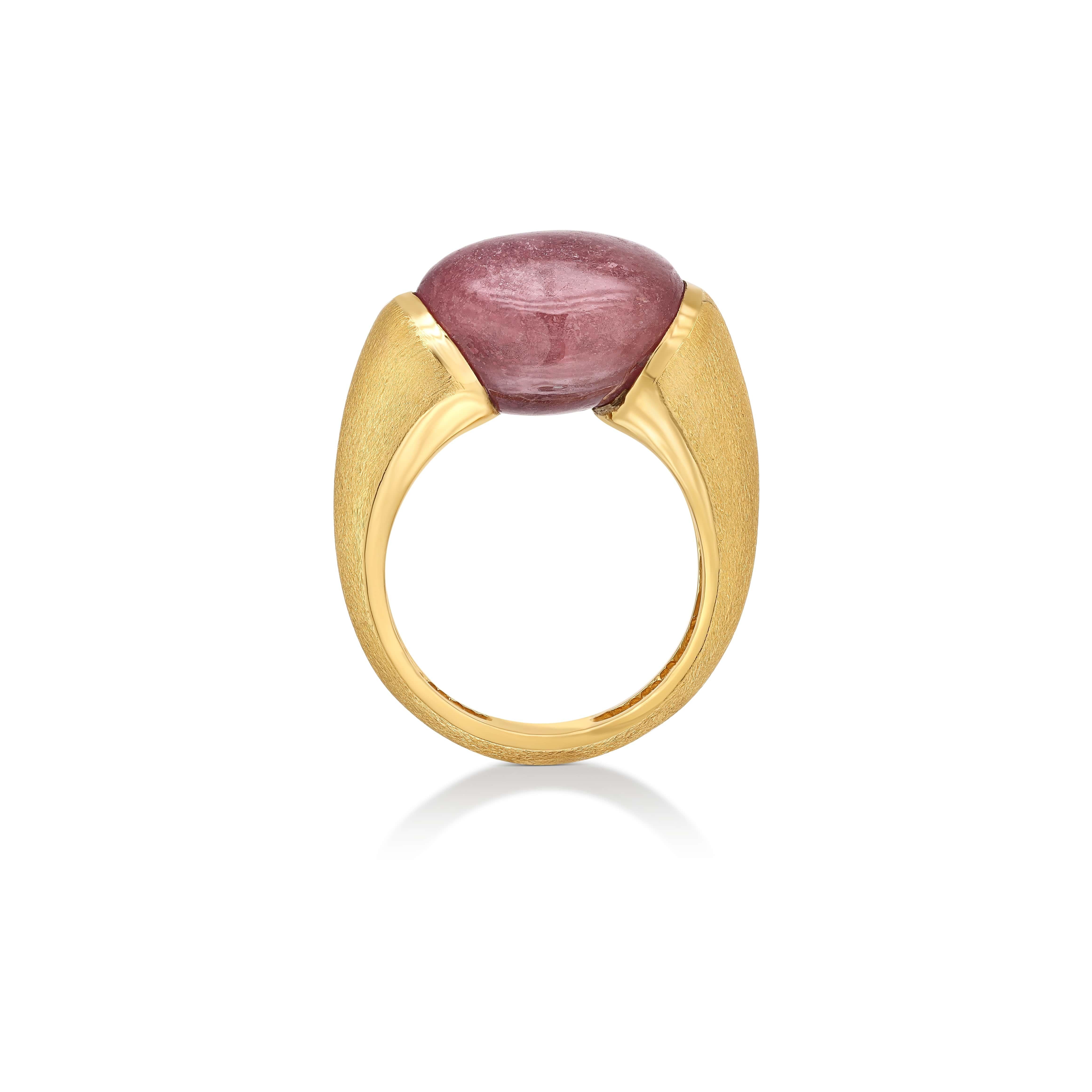 The Red Sapphire Ring from Yvel’s Rainbow Collection is a stunning display of vibrant color and elegant design. The ring features a substantial 21 ct. natural red sapphire, its cabochon cut showcasing the gem’s rich, deep hue. The satin finish of