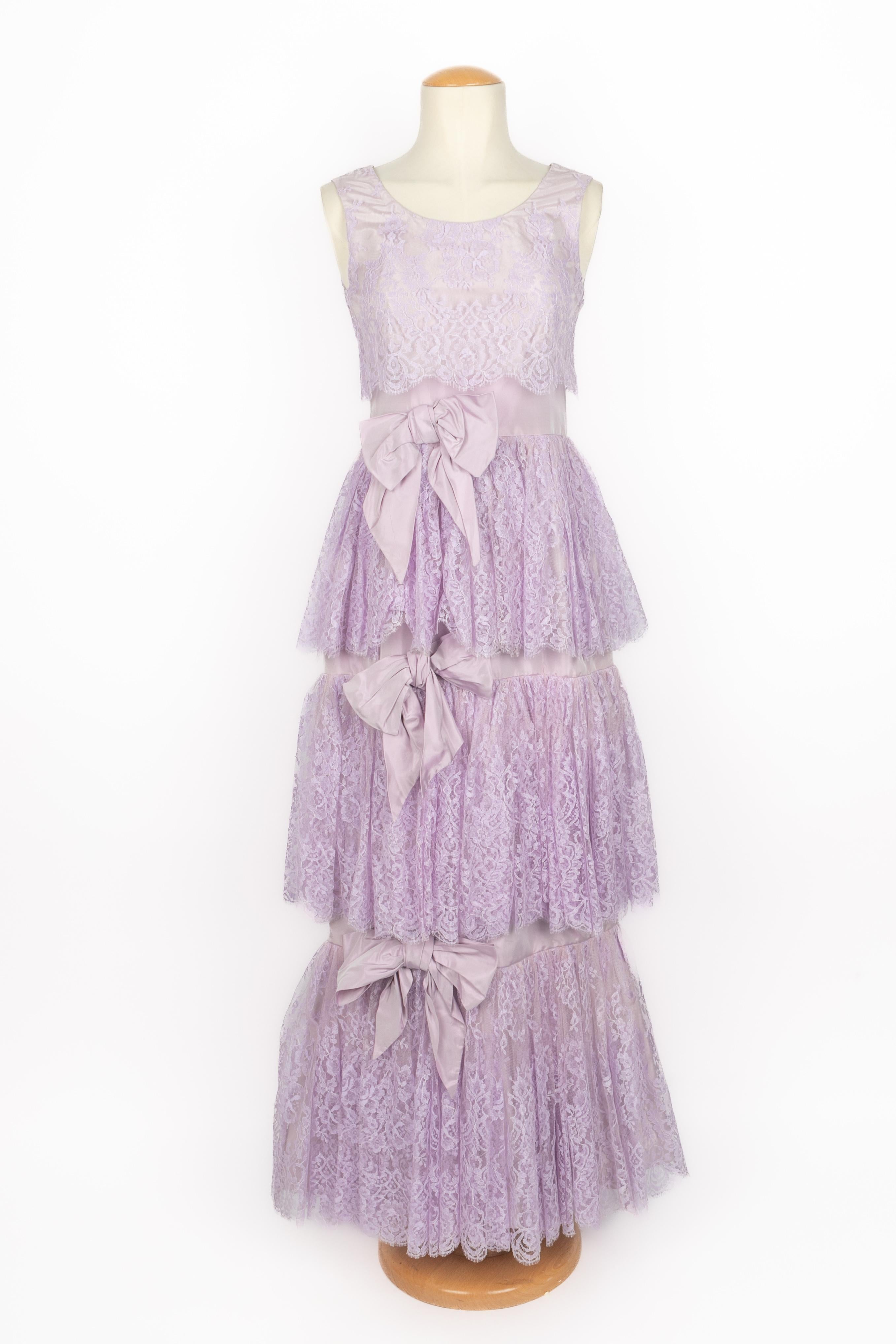YVELINE FERMINE - Robe en taffetas lilas recouverte de dentelle et ornée de nœuds. Aucune taille n'est indiquée, il convient à un 36FR/38FR. Pièce des années 1960.

Condit :
Bon état

Dimensions :
Poitrine : 39 cm - Taille : 33cm - Hanches : 45 cm -