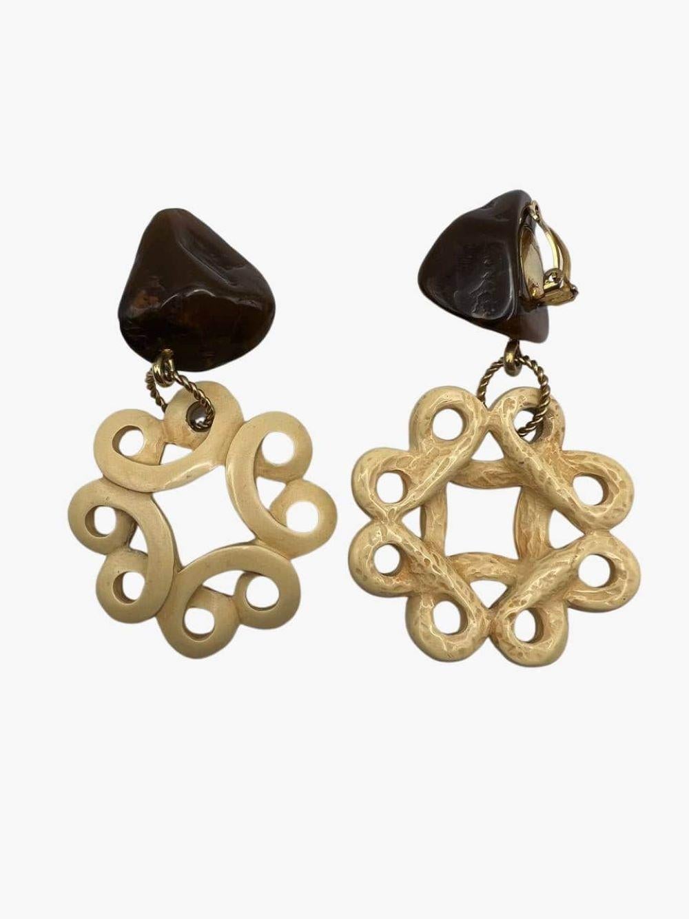 Vintage massive ivory and dark-brown resin drop earrings by Yves Saint Laurent. Features openwork dangling circles. 
Gold-tone metal clip-on closure. 
Signed. YSL mark on the clasp. 
Year: 1967 (SS67 African Collection)
Length: 8cm
Width: 5cm