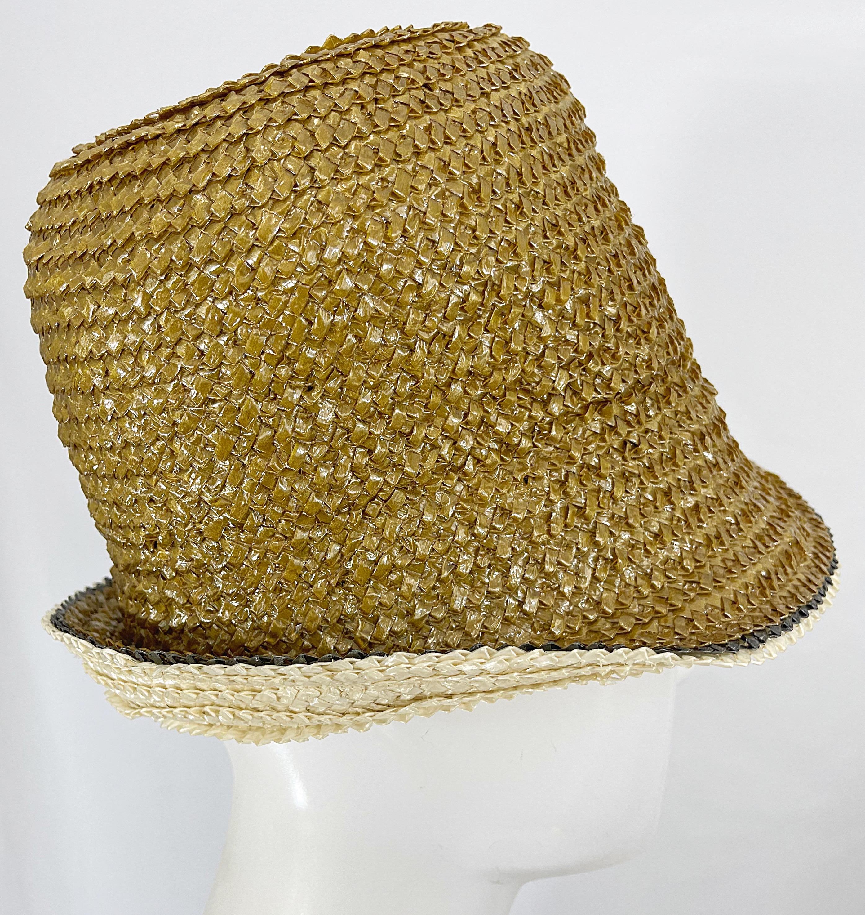 Chic 1960s YVES SAINT LAURENT gold raffia straw cloche hat ! Features a beautiful muted gold. Can be worn multiple ways, as pictured. Pair with jeans and a tank, a dress, etc. Great for anytime of year. 
In great condition
Made in France
Inner