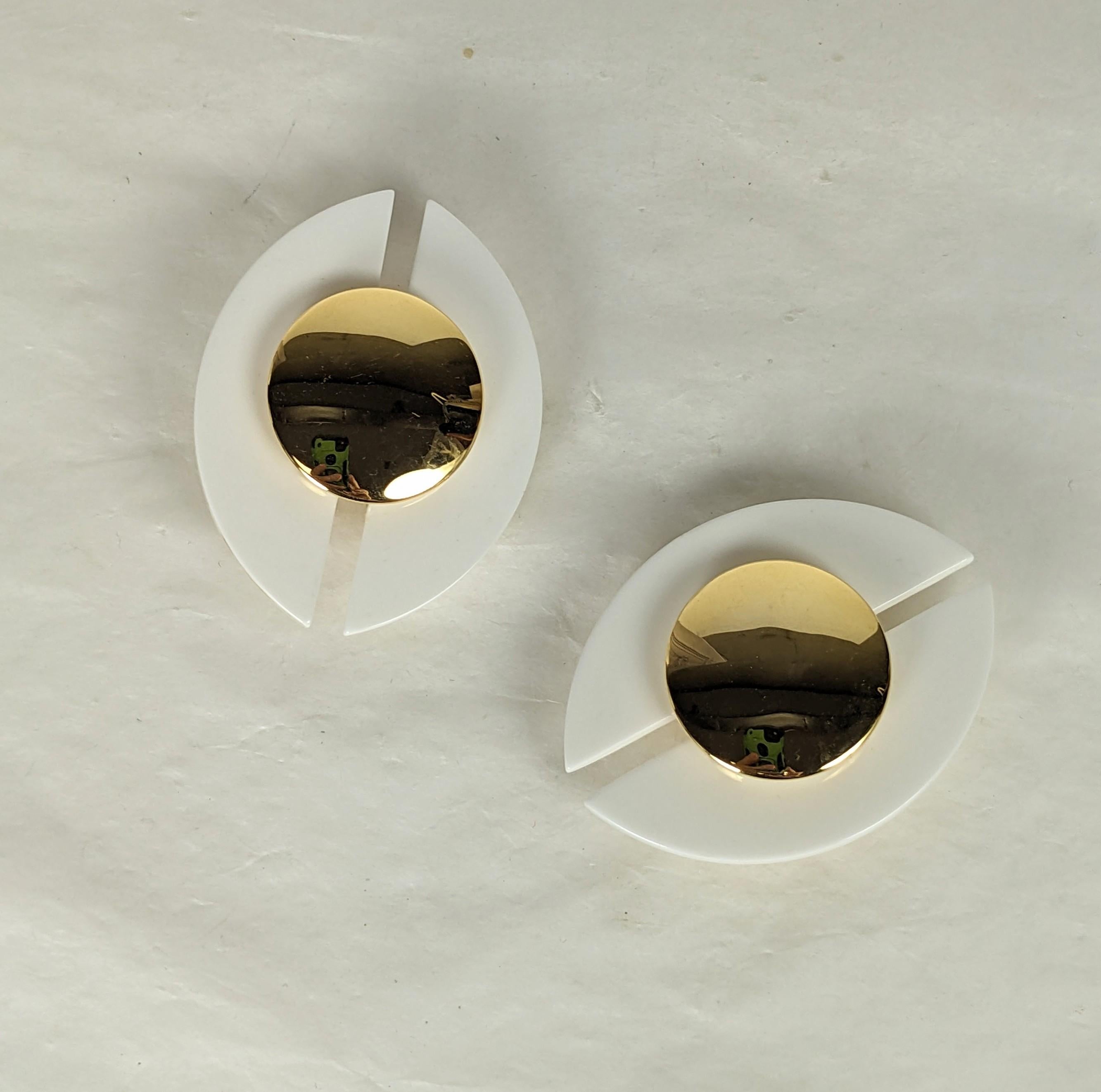 Yves Saint Laurent 1970s large bakelite earclips. Designed in the Art Deco Revival taste of white bakelite overlapping elliptical half ovals, set with round gilt rounds. Designed by Maison Denez. Excellent Condition, Unsigned. Clip back fittings.