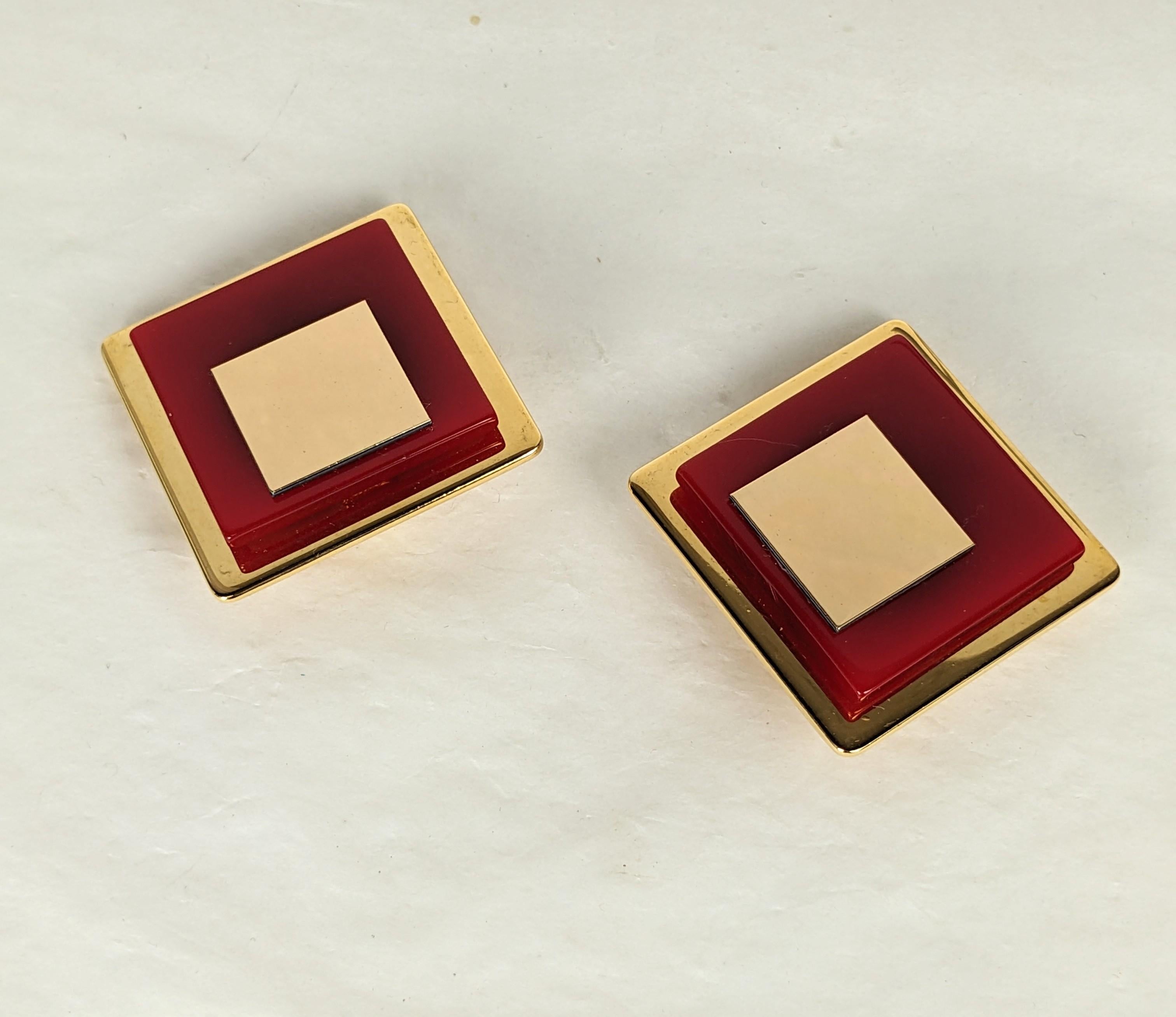 Large scale Yves Saint Laurent 1970s bakelite earclips.  Designed in the Art Deco Revival taste, red bakelite squares and polished gold plate. Designed by Maison Denez. 
Excellent Condition, Unsigned. Clip back fittings. 
Length 1 1 /16 