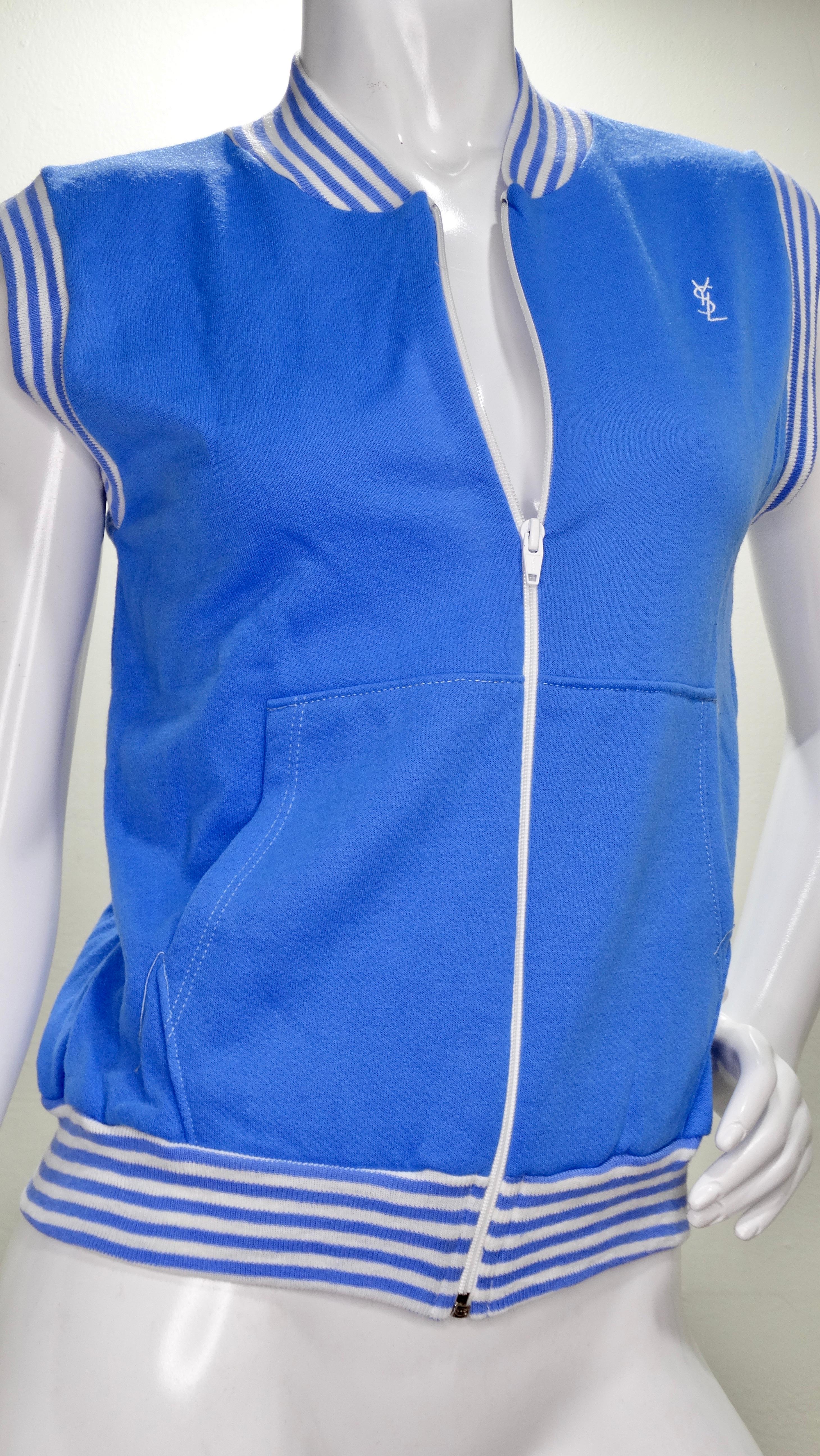Nobody does it quite like Yves Saint Laurent! Circa early 1970s, this baby blue vest from YSL's activewear line features a blue and white striped hem, YSL logo on the front, two front pockets and a white zipper closure. Original tag intact, marked a
