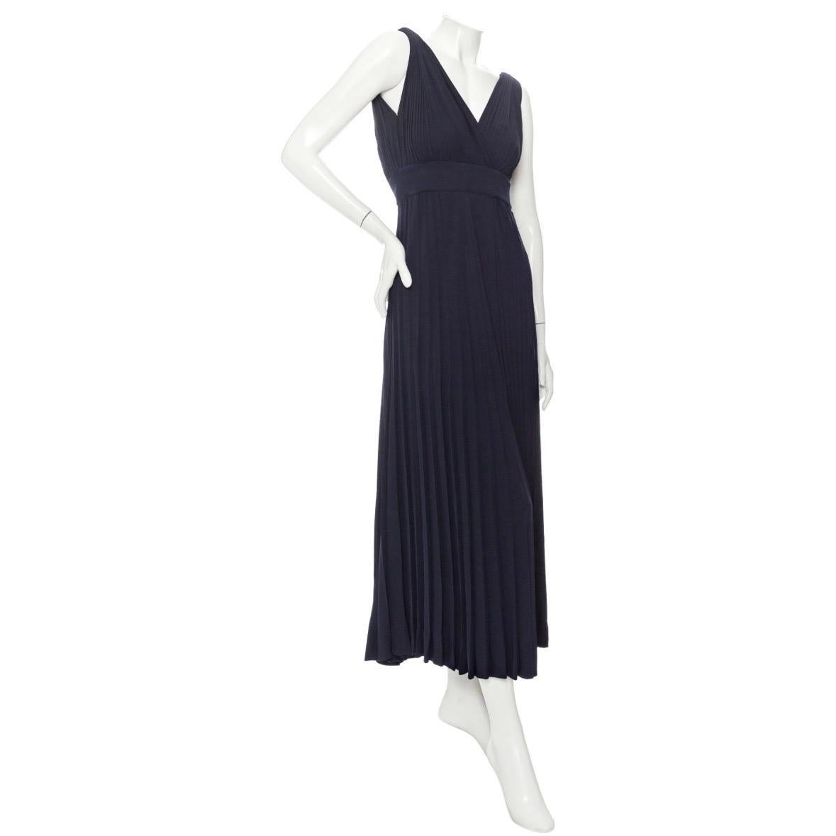 Yves Saint Laurent 1970s Navy Pleated Two-Piece Rhinestone Maxi Dress

Vintage; circa early 1970s
Haute Couture
Navy Blue
Two-Pieces; top snaps onto waistband of skirt
Pleated
Surplice v-neckline and back
Rhinestone crescents on shoulders with hook