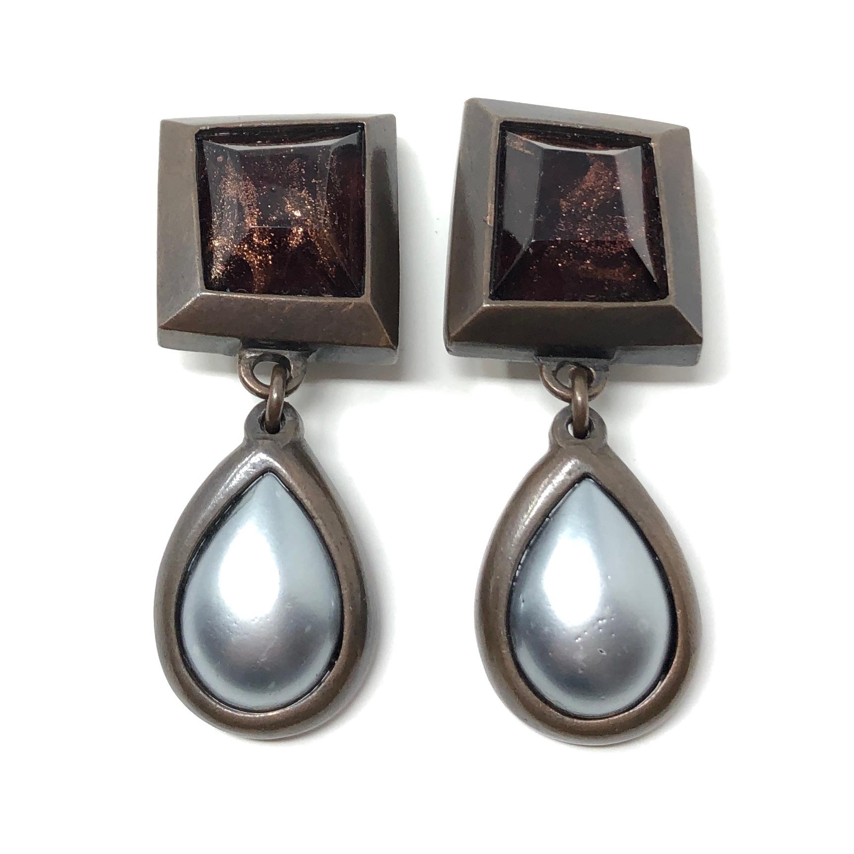 Fashion forward and striking, these earrings are a stylish 1980s Yves Saint Laurent design. They are clip on.

Condition Report:
Very Good - A tiny bit of scratching to the surface of the faux pearls. This is only visible upon very close inspection,