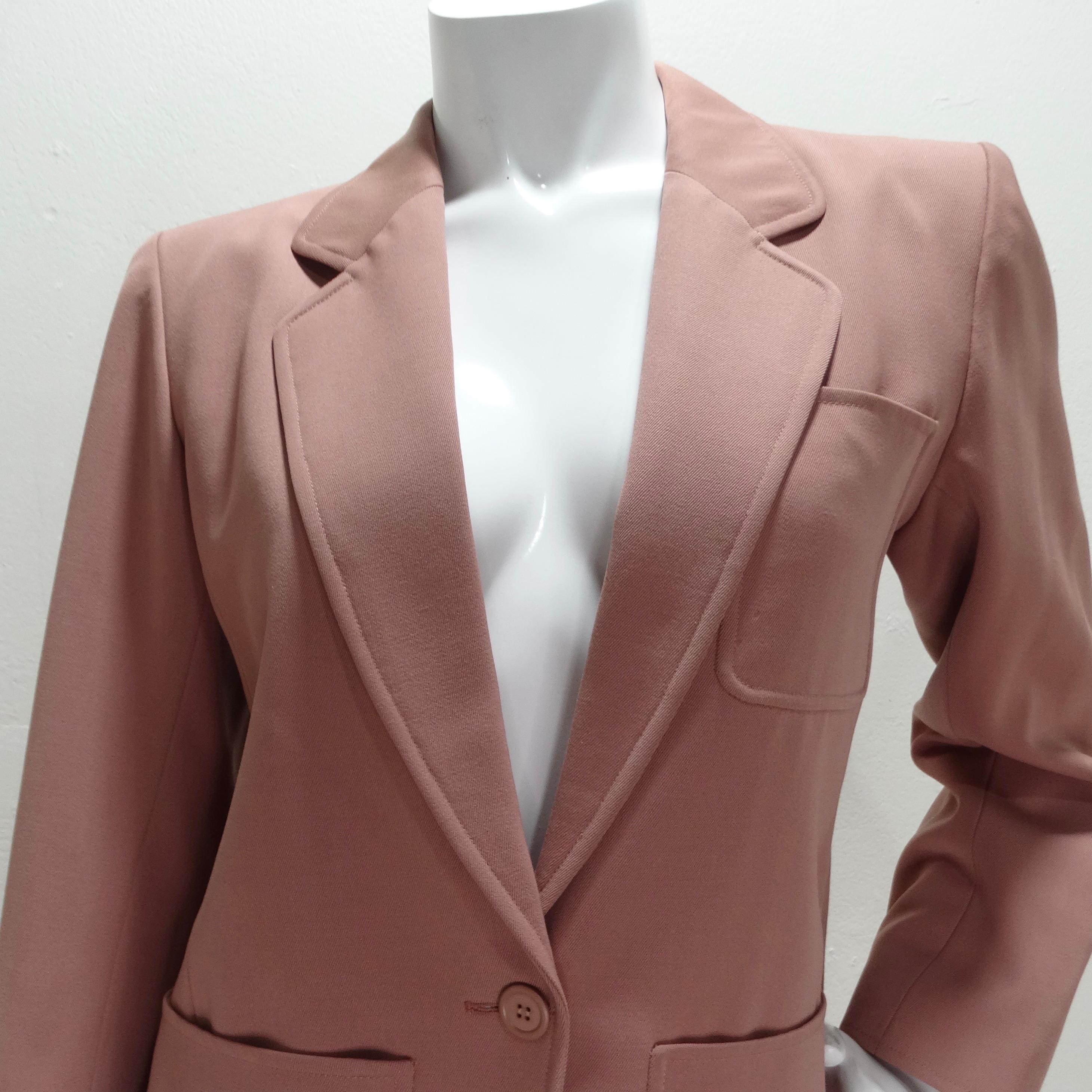 Elevate your wardrobe with the Yves Saint Laurent 1980s Blush Blazer, a classic women's blazer that embodies timeless elegance. This beautifully crafted blazer features a structured collar, two spacious center pockets, and a breast pocket, all
