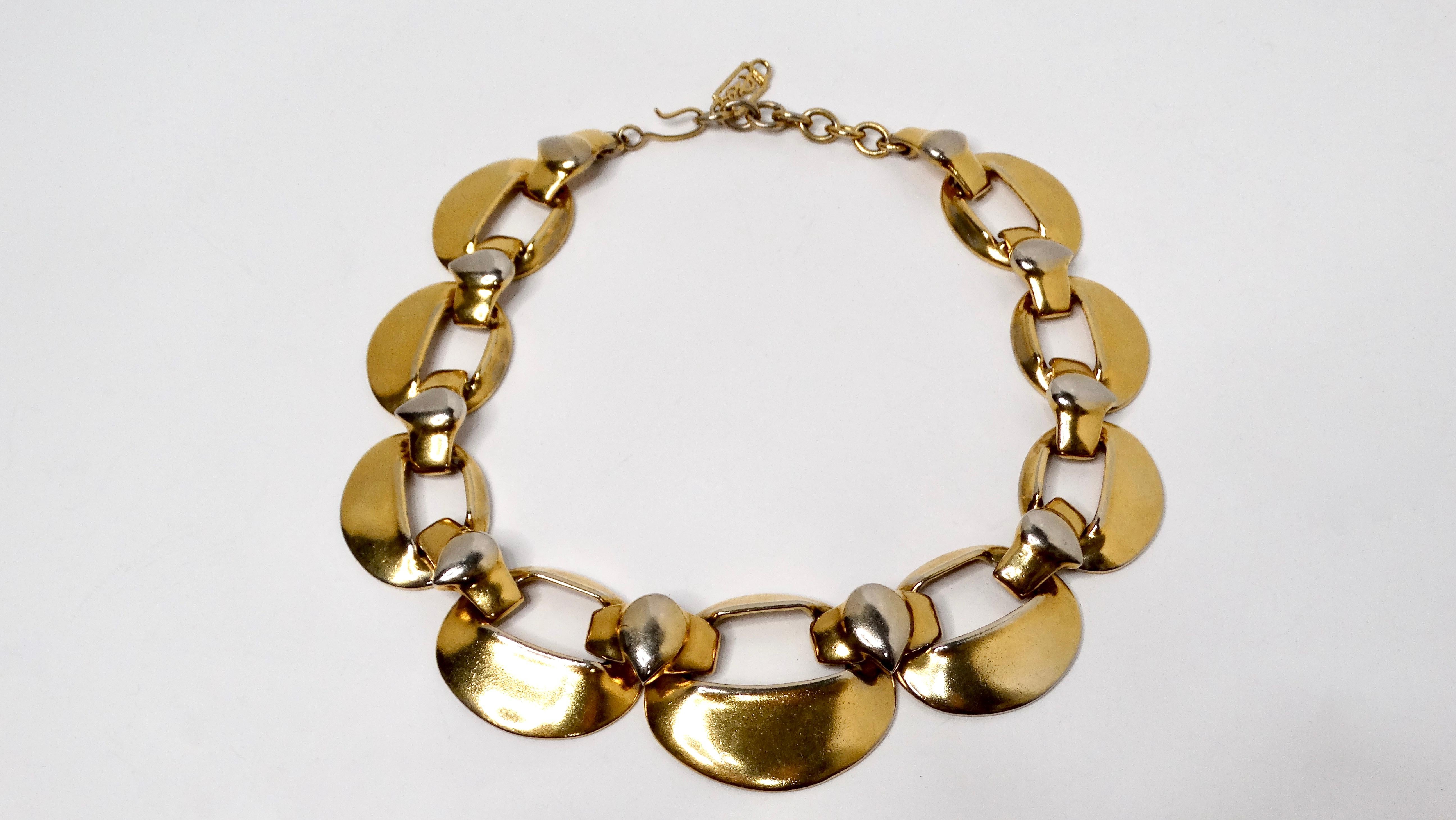 The Yves Saint Laurent 1980s Chunky Gold-Tone & Silver-Tone Statement Necklace exemplifies the bold and daring aesthetic of the era. This striking accessory features large flat chain links interwoven in a mixed metal design, adeptly blending gold