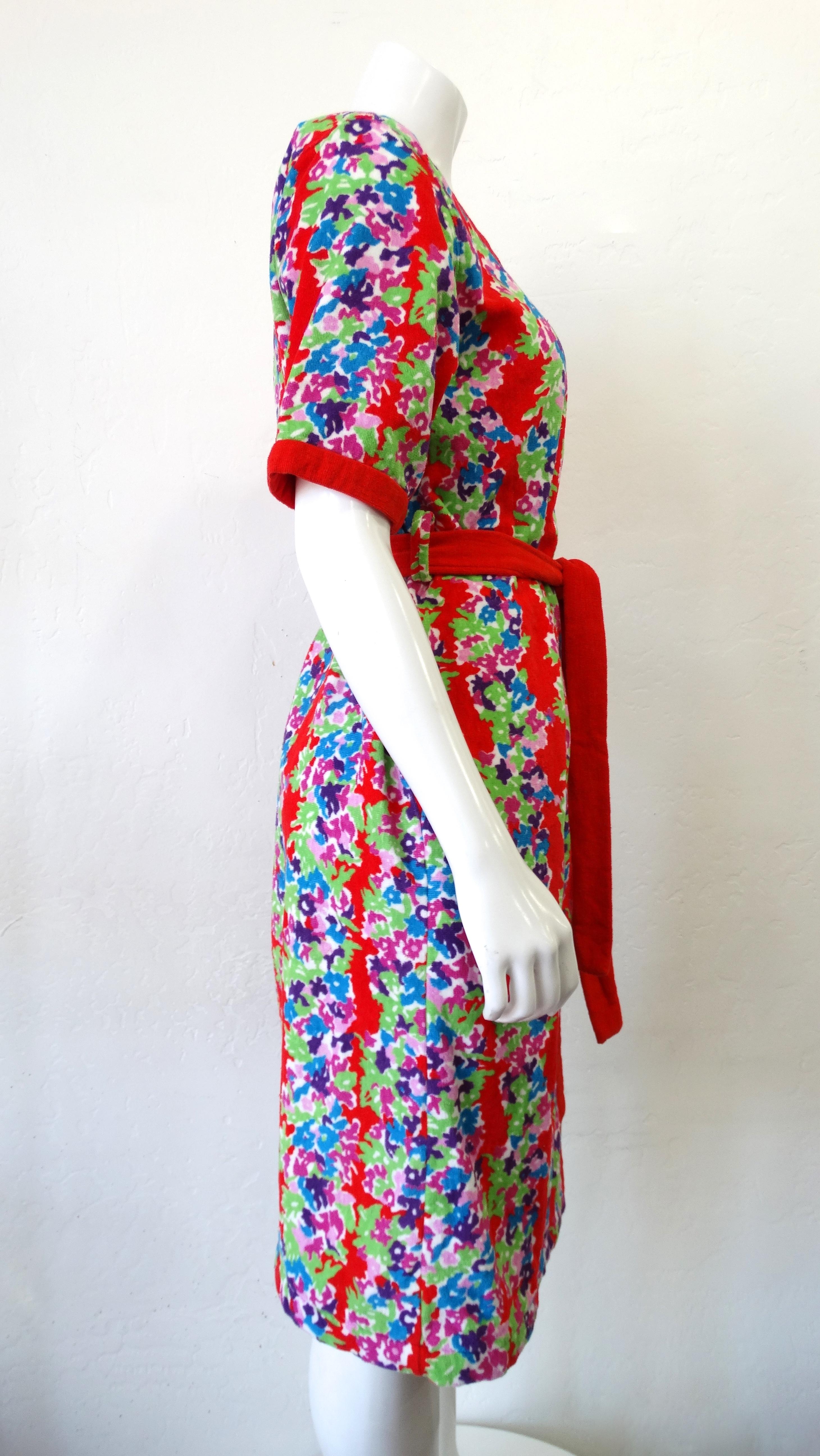 Lounge in style with this adorable Yves Saint Laurent dress! Circa early 1980s, this YSL midi dress is crafted from terry cloth and features a vibrant floral pattern with a red trim and roomy straight fit. Includes a scoop neckline, short sleeves, a