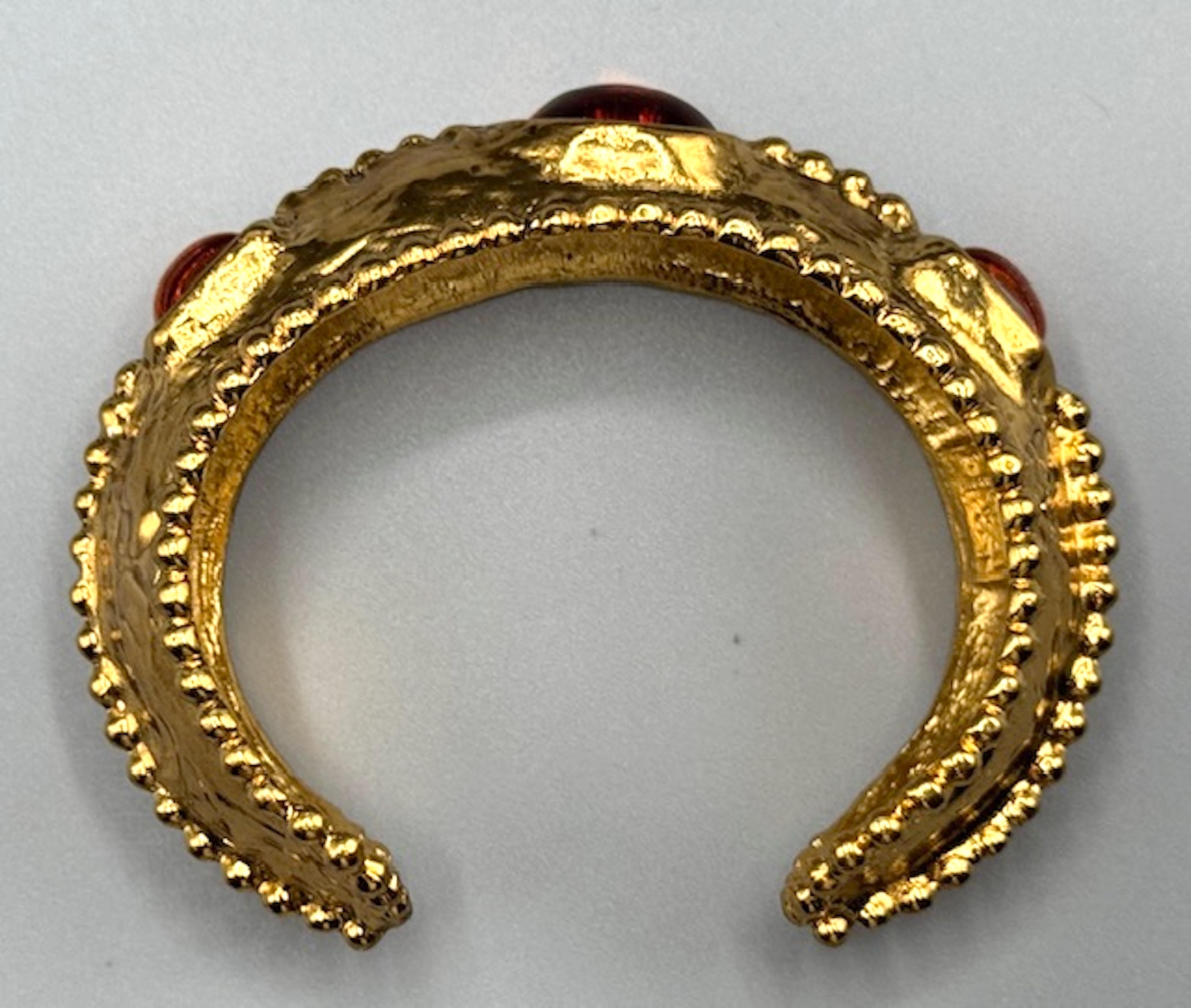 This piece is a stunning example of Yves Saint Laurent’s collaboration with Robert Goossens, a renowned French jewelry designer known for his intricate craftsmanship. The hammered Martelé finish, combined with the beadwork detailing, gives the