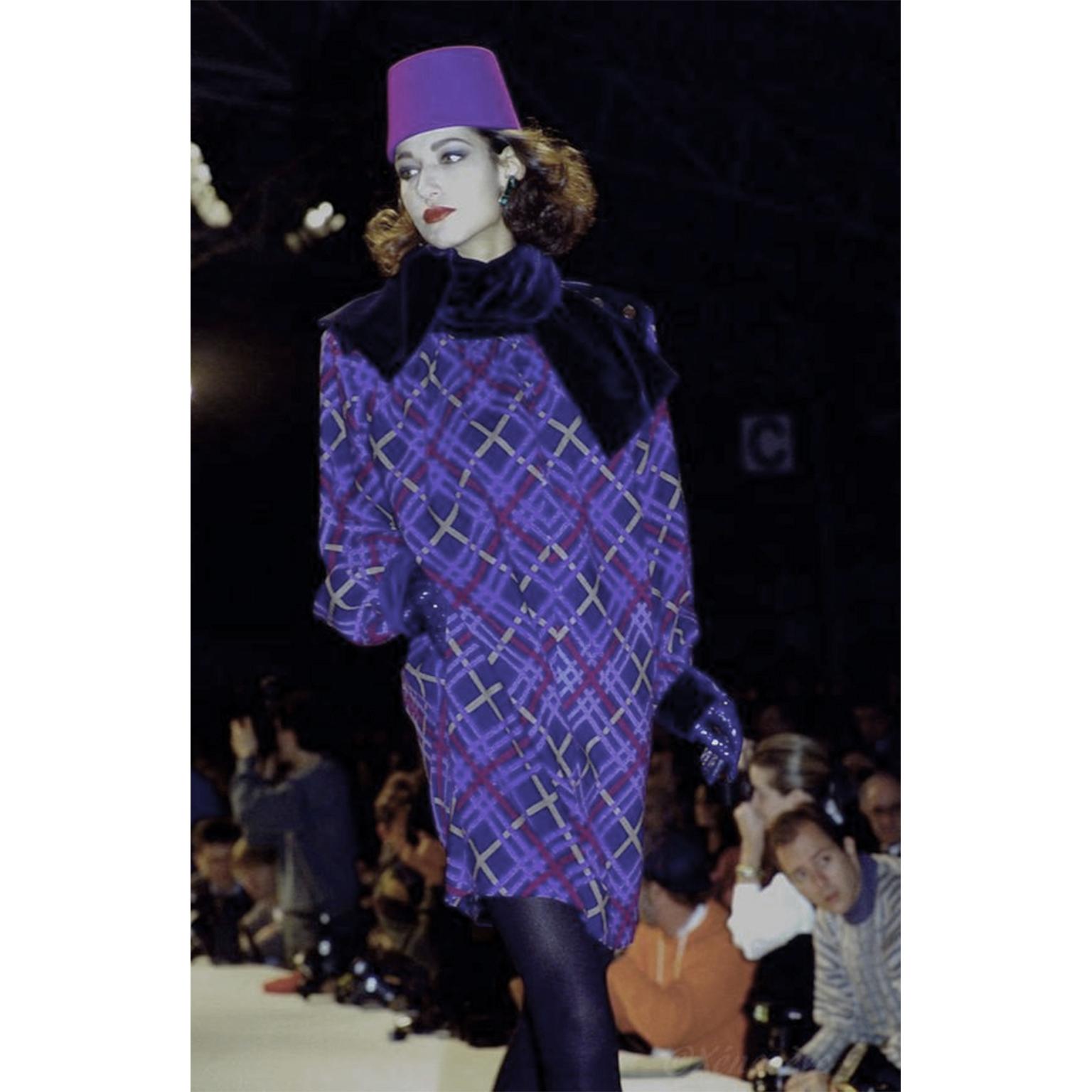 This is an Yves Saint Laurent beautiful plaid wool dress from the YSL F/W 1985 collection. The dress has a saturated shades blue, purple and gold in a plaid, with a dark blue velvet on the shoulders and on the mock turtleneck. This dress opens with