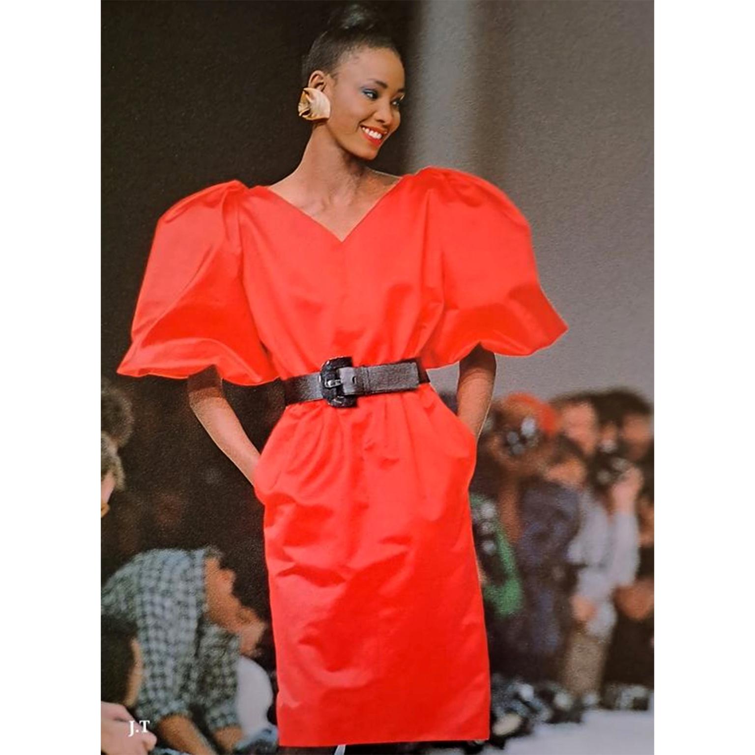This stunning vintage Yves Saint Laurent red dress was featured on the YSL runway. for the Spring Summer 1989 collection. This fabulous dress is in a luxe red cotton fabric and has the signature YSL puff sleeves with beautiful gathering at the