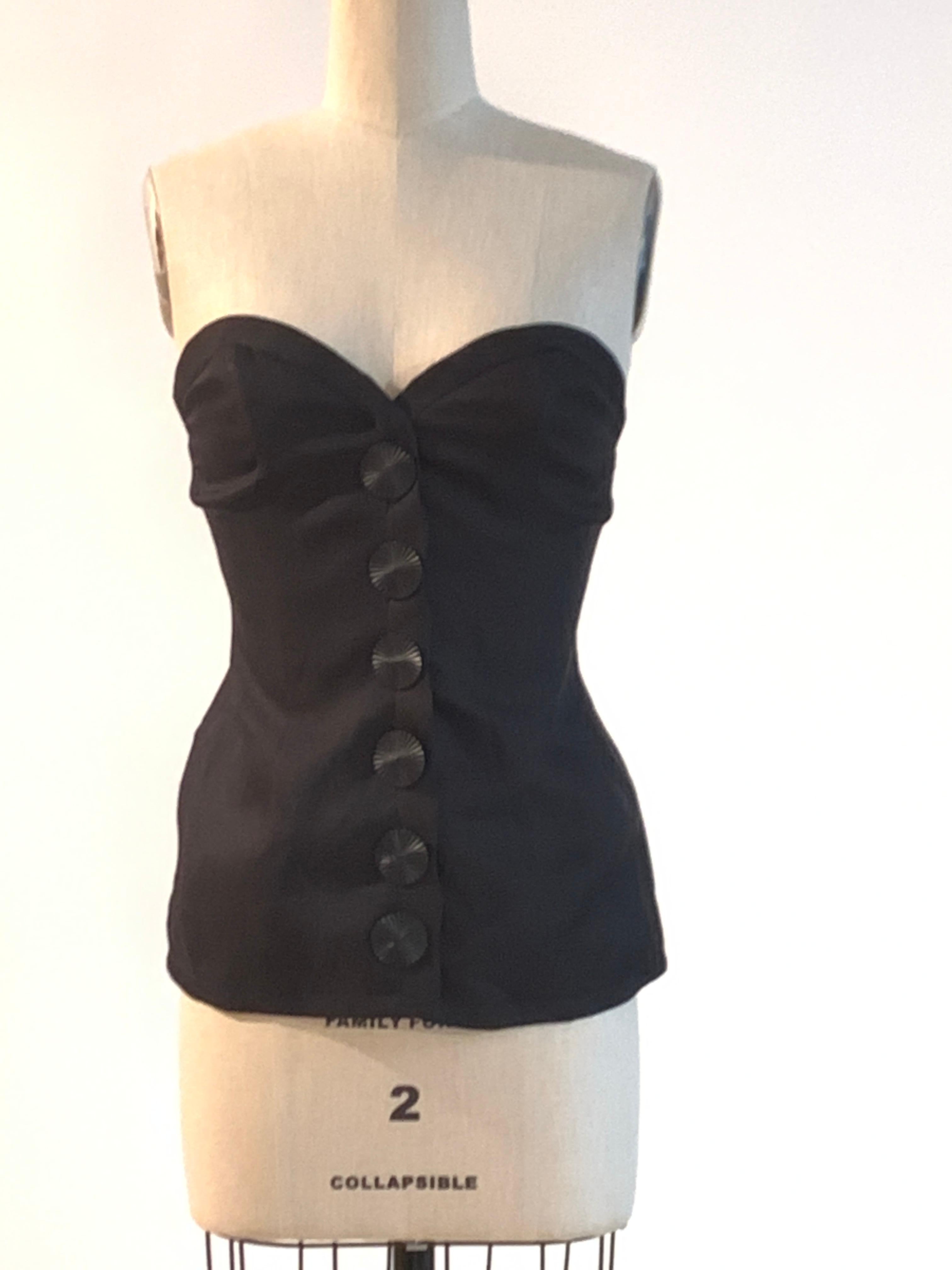 Yves Saint Laurent vintage 1990s strapless structured corset style top with sweetheart neckline and novelty  button closure at front. Boning at top front and top sides. Fastens at front with buttons and a snap and hook at top. 

100% silk.
Fully