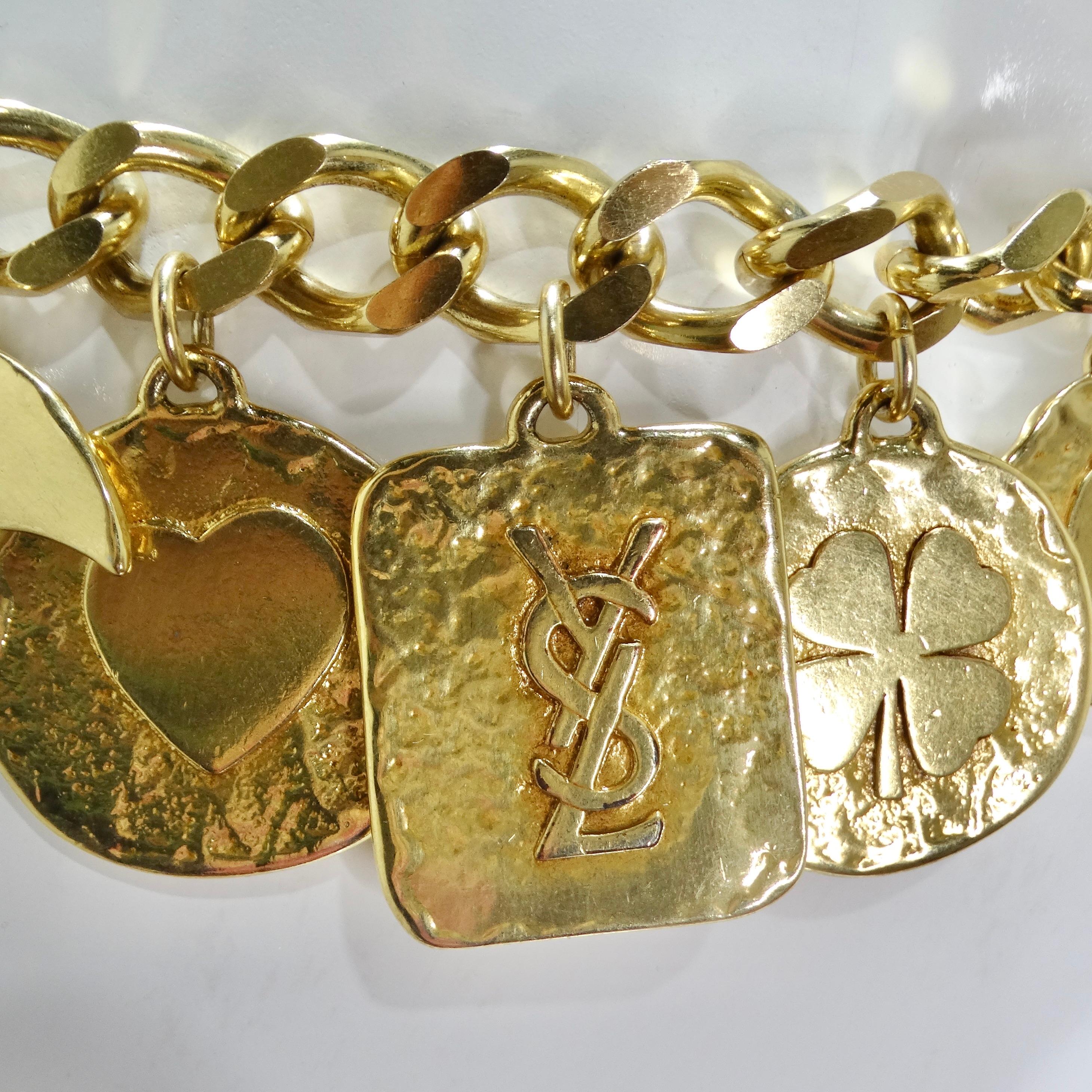 Introducing the Yves Saint Laurent 1990s Gold Tone Charm Chain Belt – a rare and exquisite piece designed by the iconic Yves Saint Laurent in the early 1990s. This fabulous belt is a true collector's item, boasting a timeless design that exudes