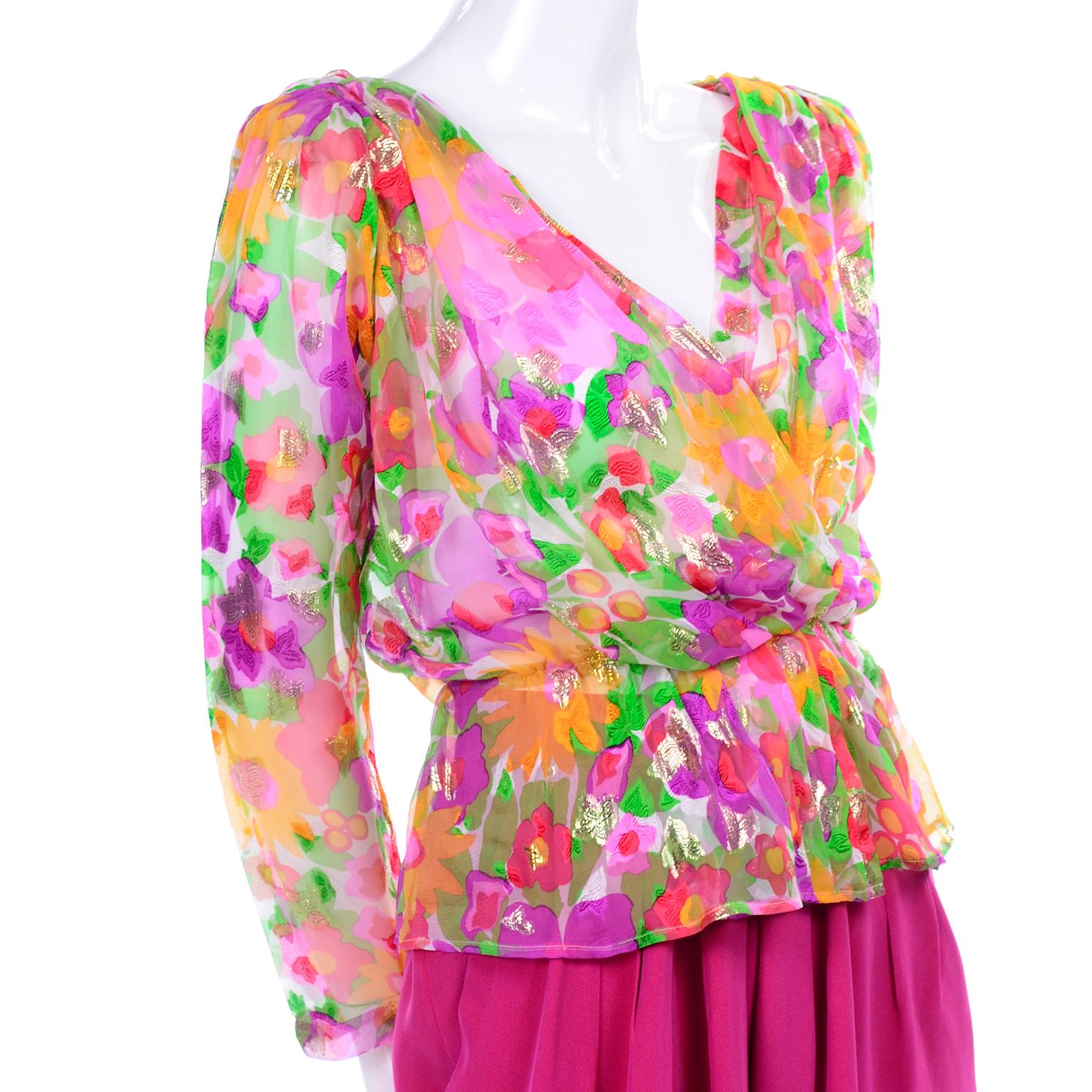 This is a wonderful Yves Saint Laurent Rive Gauche ensemble from the 1990's with high waisted, pleated leg pink pants and a gorgeous sheer cropped peplum blouse! The blouse is sheer, in a pink, yellow, orange and green floral pattern, speckled with