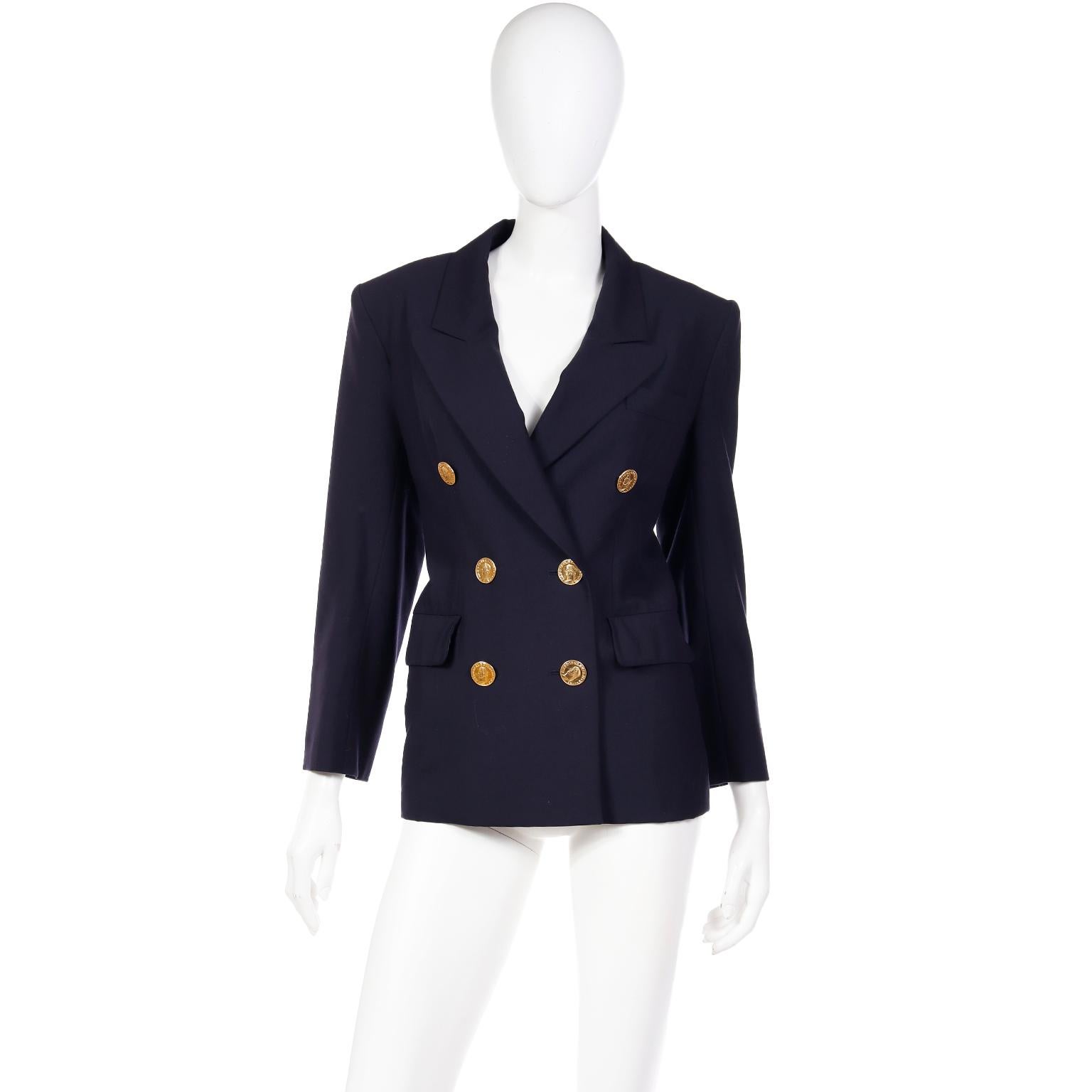 This Yves Saint Laurent navy blue wool blazer is from the YSL Spring / Summer 1991 Rive Gauche collection. This wonderful jacket has unique gold faux coin front button closures that add so much interest to the piece! Blazers like these can elevate
