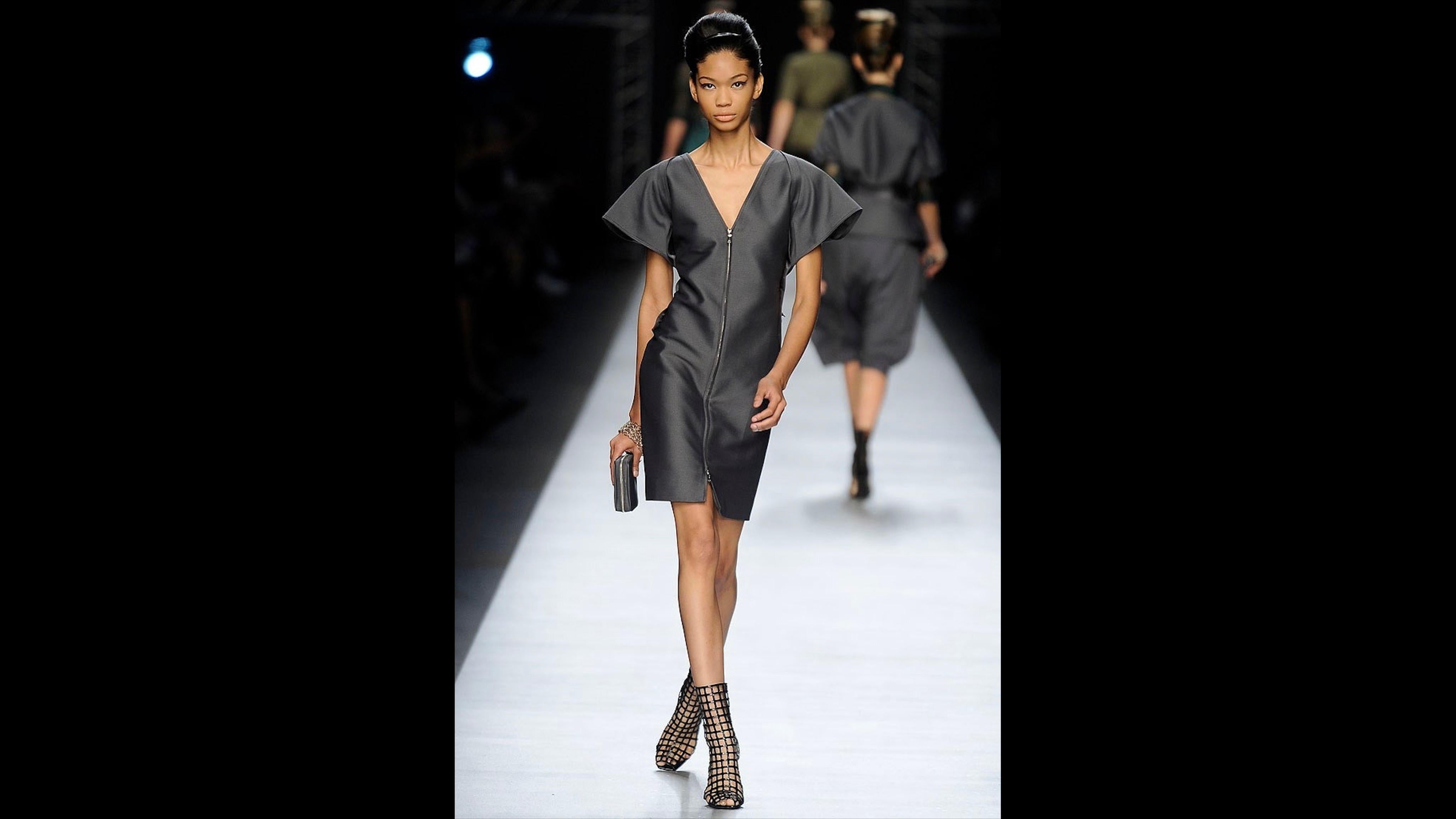 The Yves Saint Laurent 2009 Runway Black Patent Leather Cage Boots are an iconic statement piece that captures the daring glamour of the collection. These striking boots feature a unique cage design meticulously crafted in sleek black patent