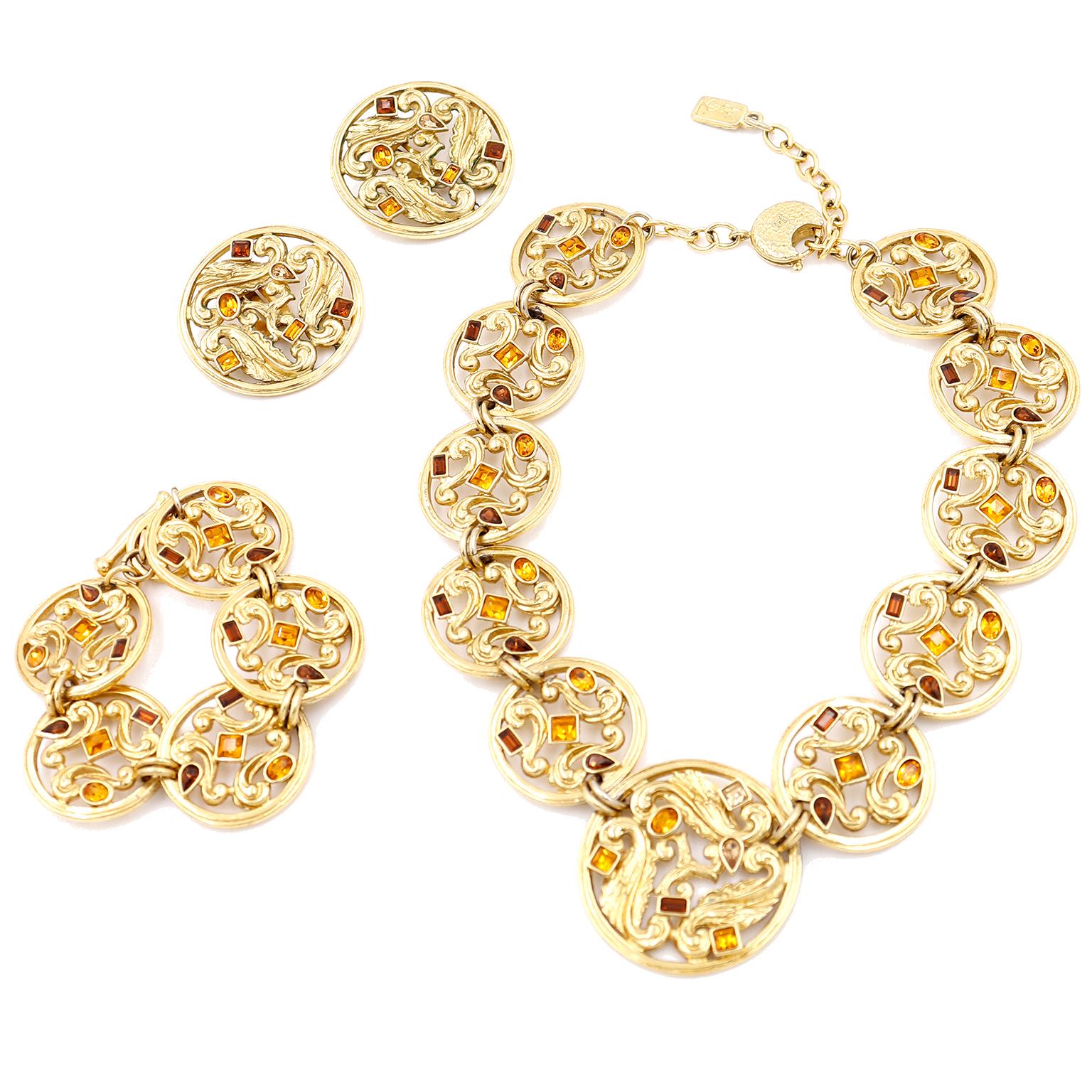 This is an incredible 1980's full 3 piece gold plated jewelry set from Yves Saint Laurent. This set includes a necklace, a pair of clip on earrings and bracelet. YSL jewelry is particularly collectible and it becomes even more so when you are able