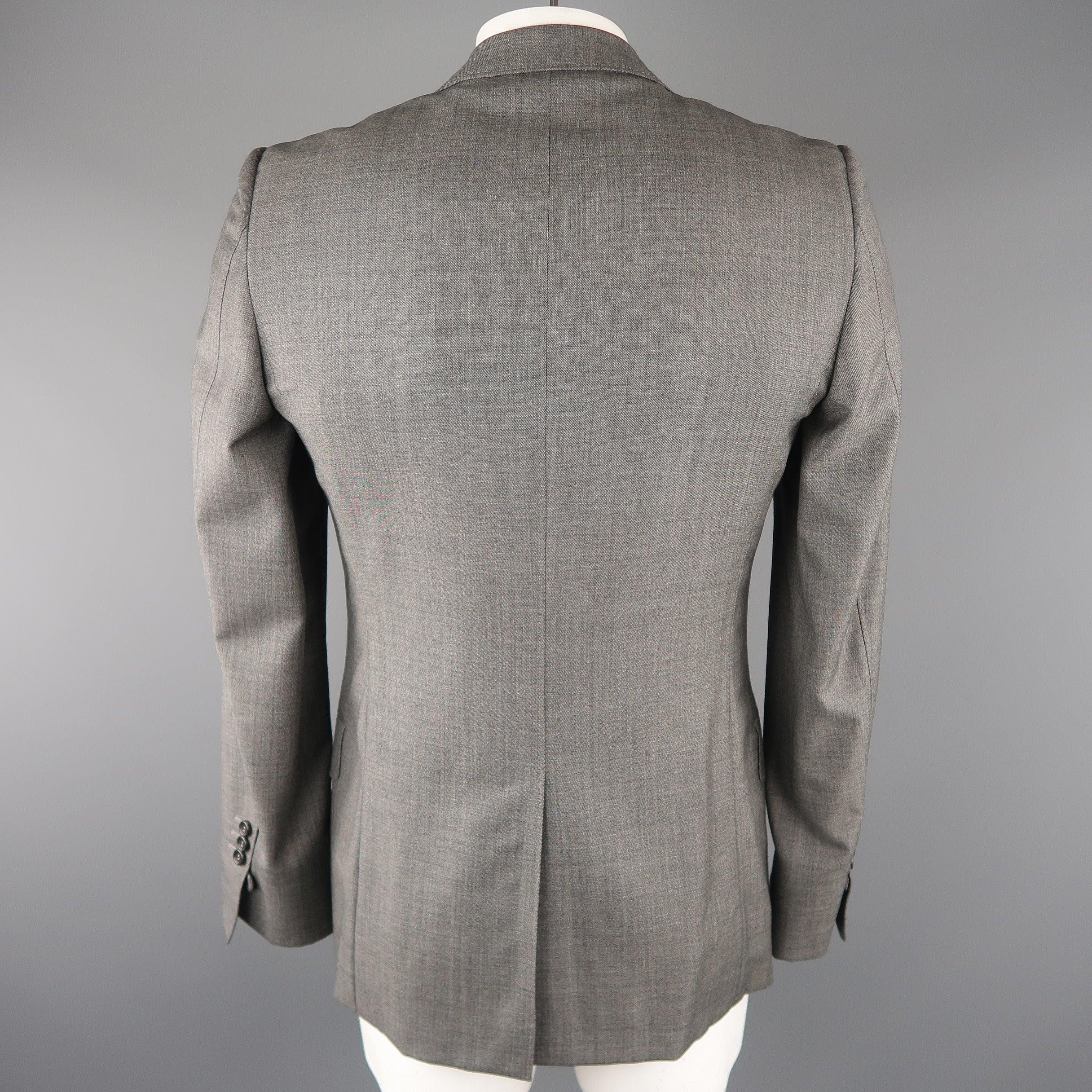 YVES SAINT LAURENT sport coat come in gray wool featuring a notch lapel, slit pockets, and a two buttons closure. Made in Switzerland.
Excellent Pre-Owned Condition. 

Marked:   48 R 

Measurements: 
 
Shoulder: 16
 inches  Chest: 42
 inches 