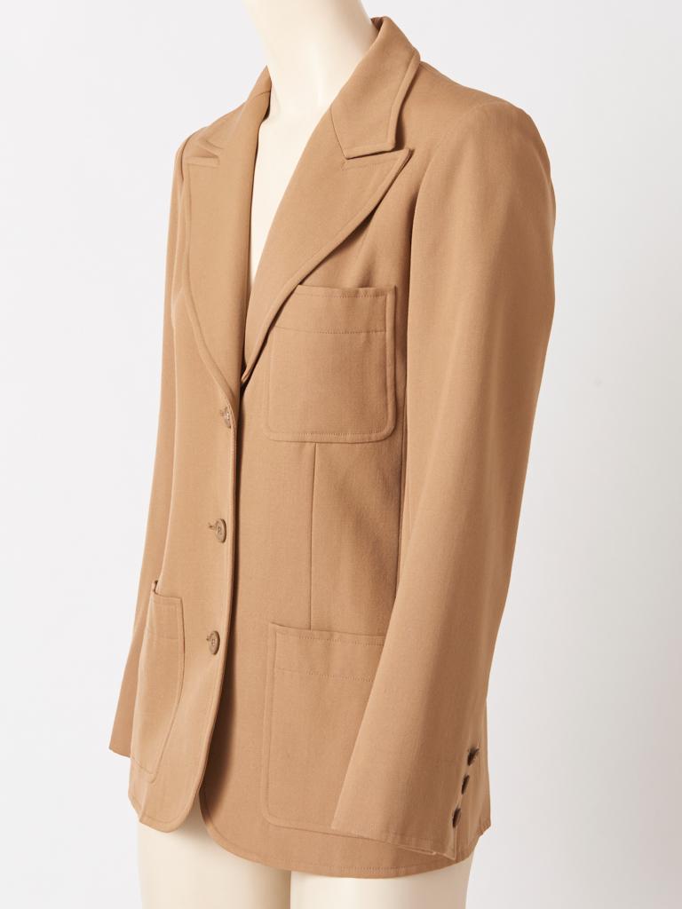 Yves Saint Laurent, Rive Gauche, camel tone, wool twill, classic 70's blazer, having a 3 button closure, large patch pockets at the hip and a wide notched lapel collar.