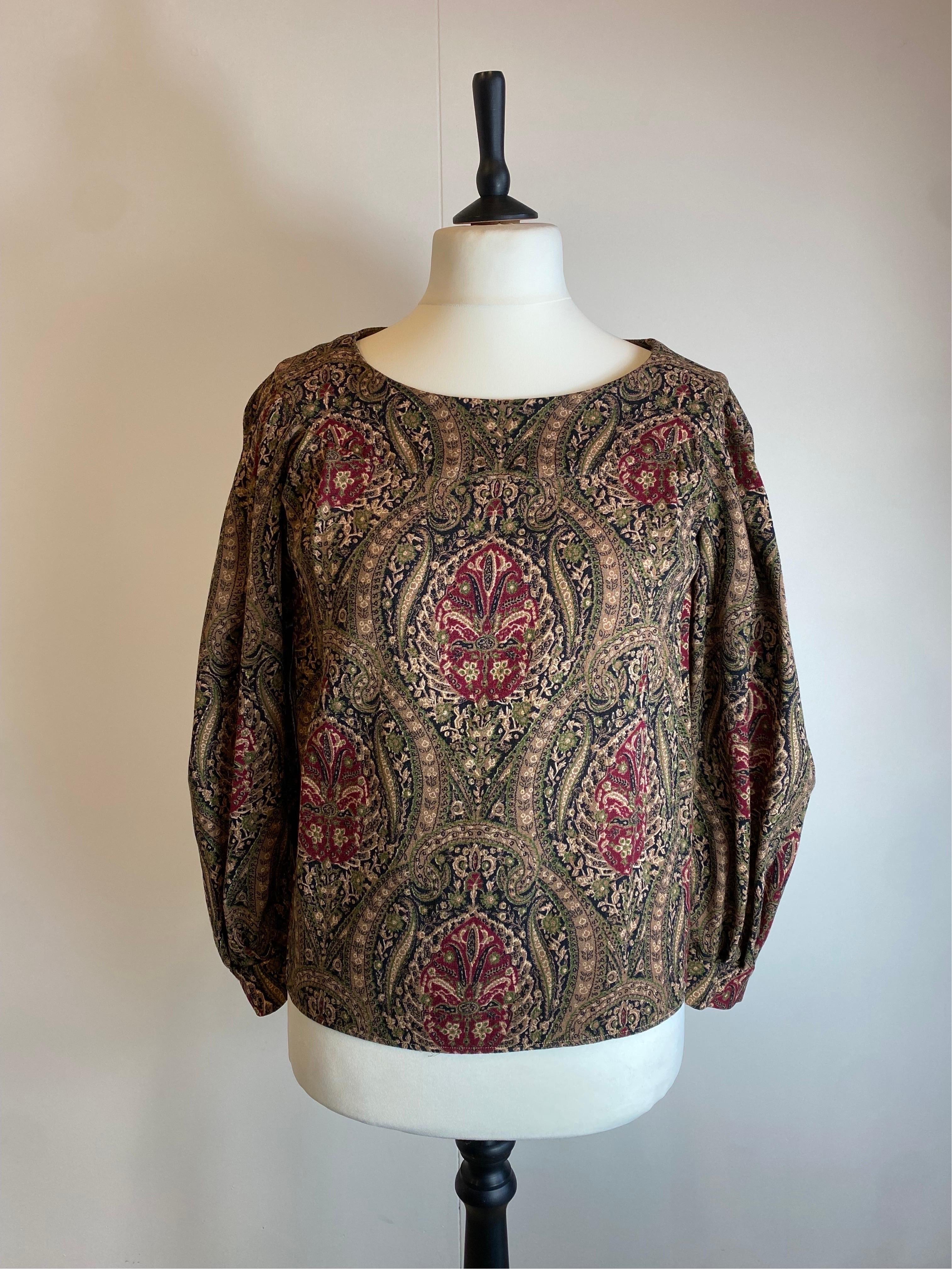 Yves Saint Laurent blouse.
Vintage item. 80s.
Floral damask paisley print
composition label missing. 
We think it's a wool blend.
Size 36 French
Shoulders 42 cm
Bust 42 cm
Length 58 cm
Sleeve 58 cm
Excellent general condition, with minimal signs of