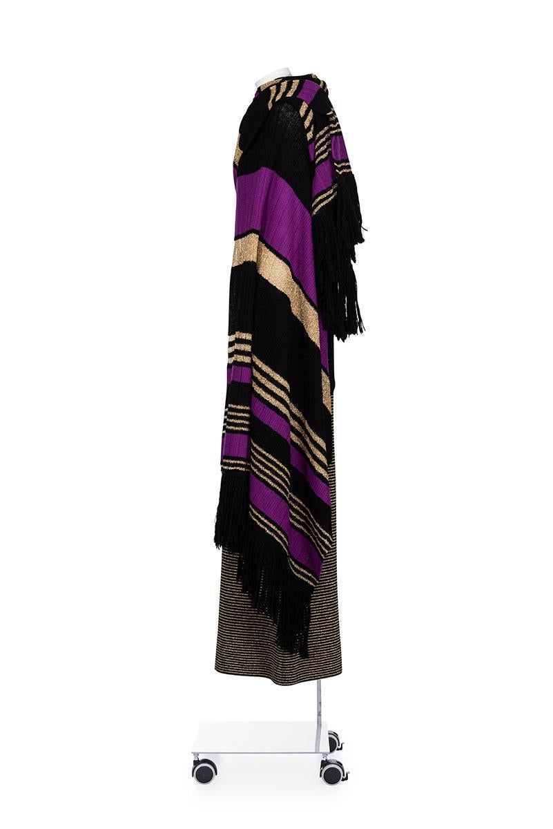 80's iconic and rare knitted suit with long skirt and shawl by Yves Saint Laurent
Lurex striped skirt with elasticated waist
Lurex striped shawl with fringes
90% wool 10% lurex

IT 42
Skirt
Waist 33 cm
Length 100 cm

Shawl
Width 83 cm
Length 213 cm