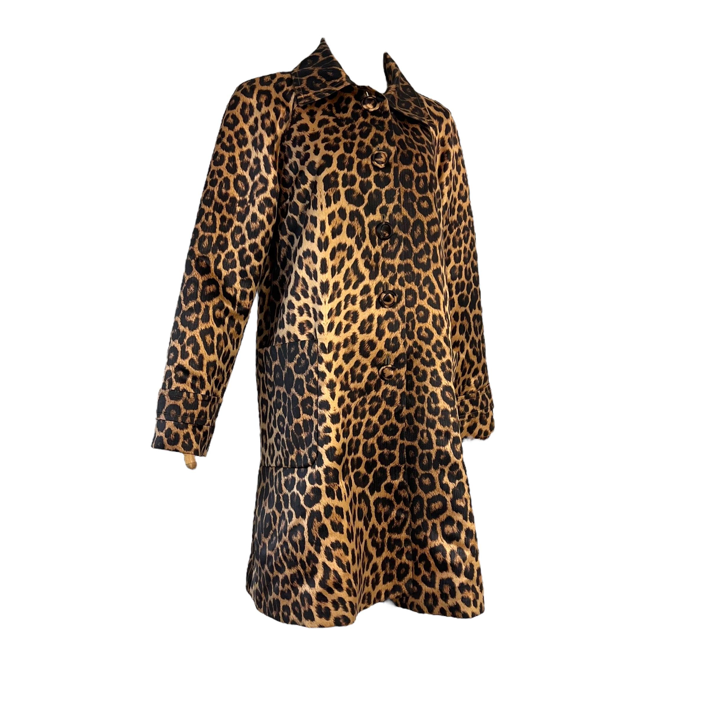 Vintage Yves Saint Laurent 90's leopard coat. Designed by a fashion icon, this vintage coat features a striking gold leopard print with a smooth lining. In good vintage condition, this 100% polyester coat is perfect for any special occasion. Made in