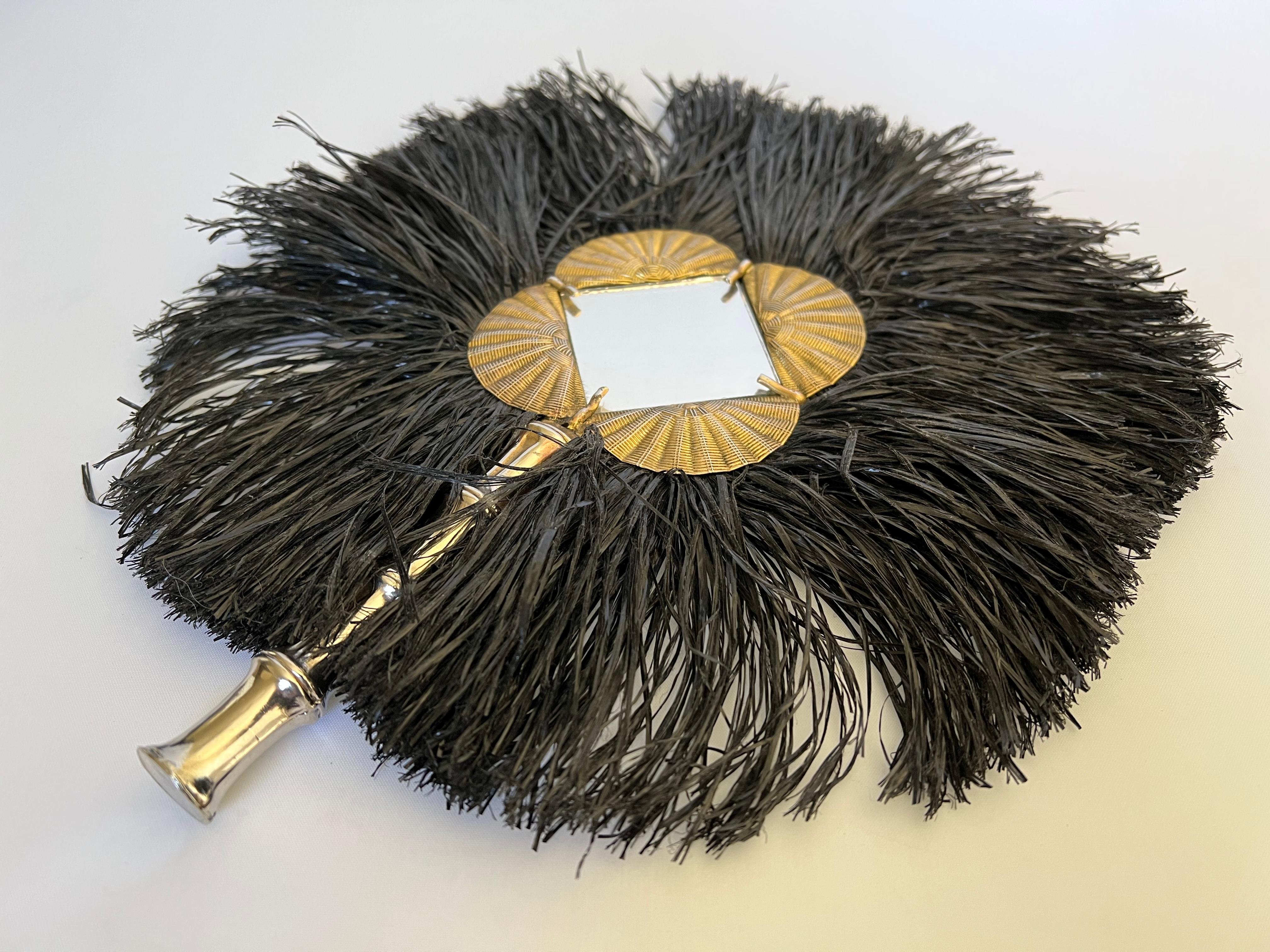 Inspired by the Mali African tribe, an extremely rare and important  Yves Saint Laurent mixed metal black raffia hand mirror from the 