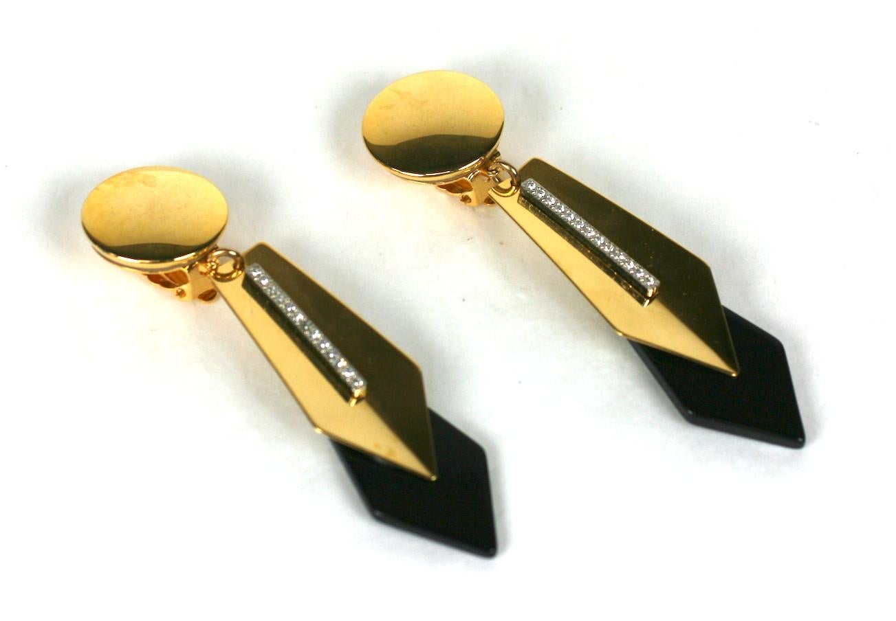 Yves Saint Laurent Art Deco Revival long ear clips circa 1970's. Of black jet resin, crystal rhinestone pave and gold plated metal. Clip back fittings. Excellent Condition. Unsigned.
Length 3.50 x Width .75