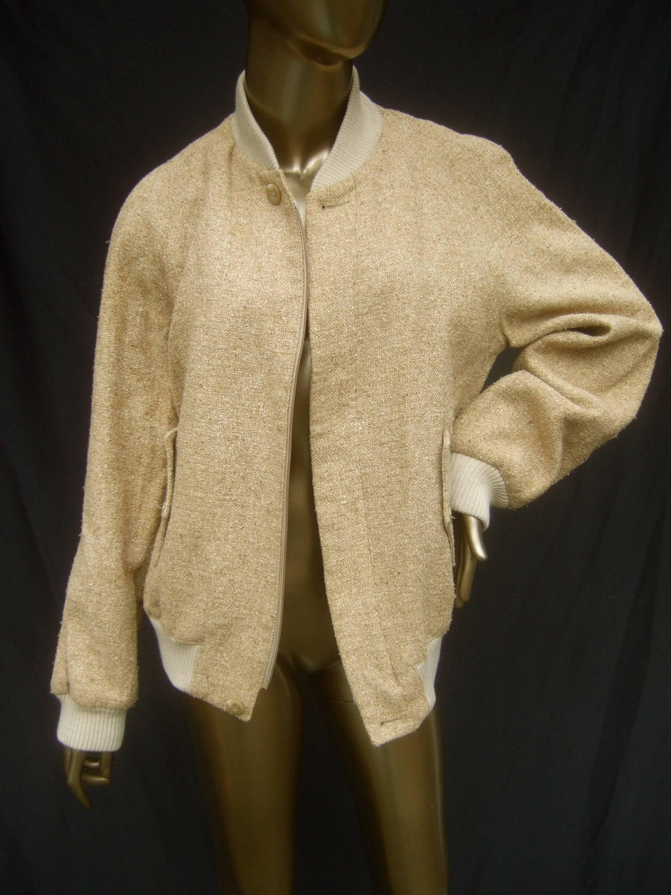 Yves Saint Laurent Beige burlap linen unisex zippered jacket c 1970s
The sand color jacket is designed with a textured burlap
linen blend fabric that zippers down the front

The unisex style jacket is designed with raglan-style
shoulders. The
