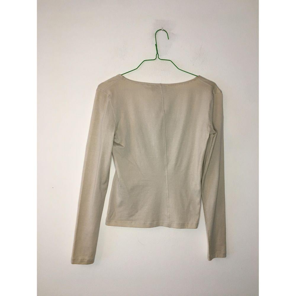 Yves Saint Laurent Beige Cotton Top

Yves Saint Laurent top. In cotton and polyurethane. Cream color \ light beige. 
Neckline supported by rigid boning. 
Size S. Measures 42 cm at the shoulders, 42 cm at the bust, 50 cm in length and 59 cm at the