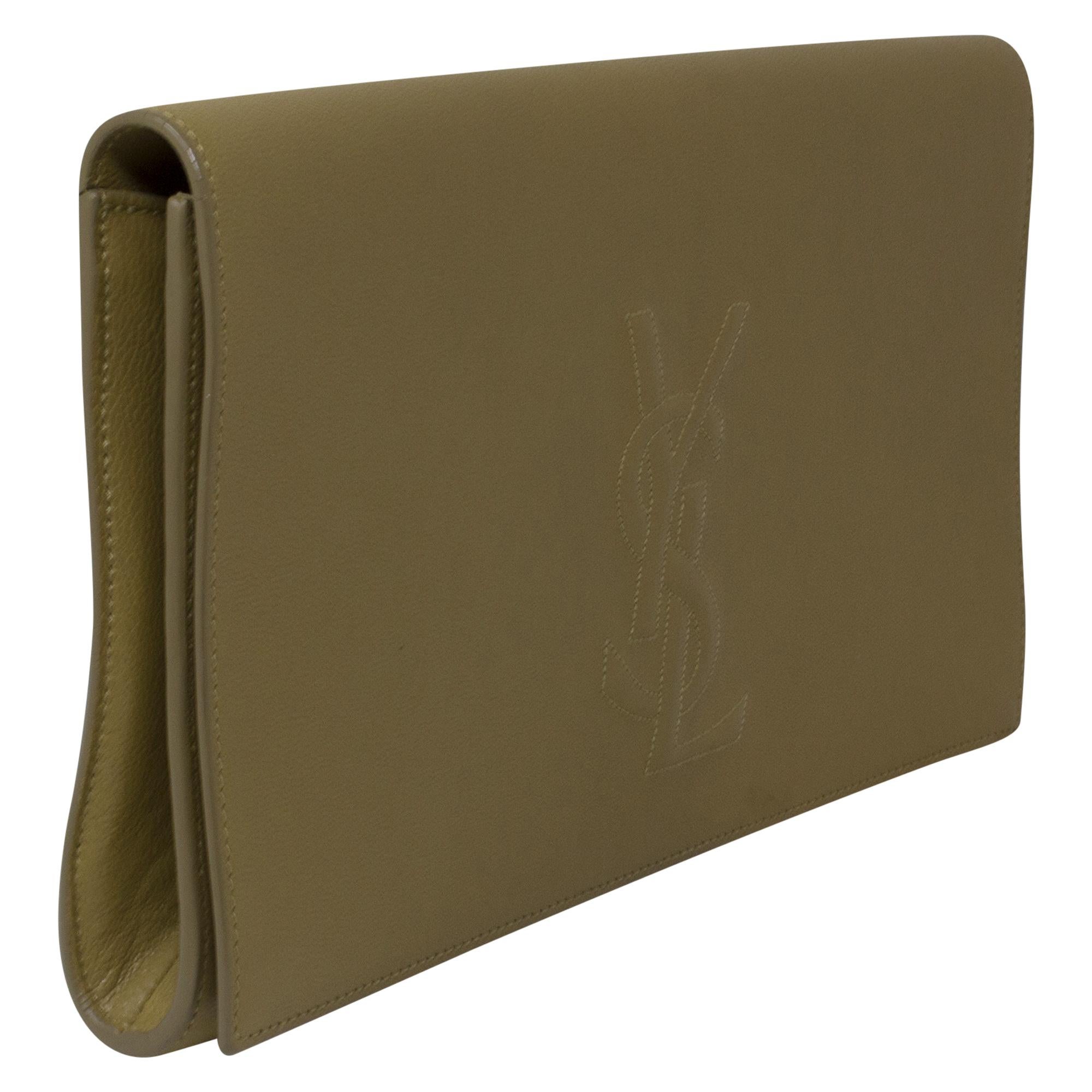 Introducing the Yves Saint Laurent Beige Patent Clutch, a chic and versatile accessory for the modern woman. Crafted from luxurious beige patent leather, this clutch exudes understated elegance and sophistication. With its sleek design and silver