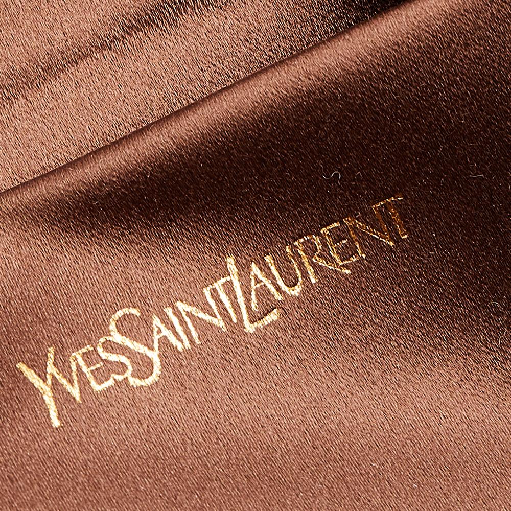 This flap clutch from Yves Saint Laurent is an elegant accessory suitable for any occasion. A large YSL logo adorns the front and gives it a luxe slant. The flap closes with a snap fastener and the interior is sized to fit all your little