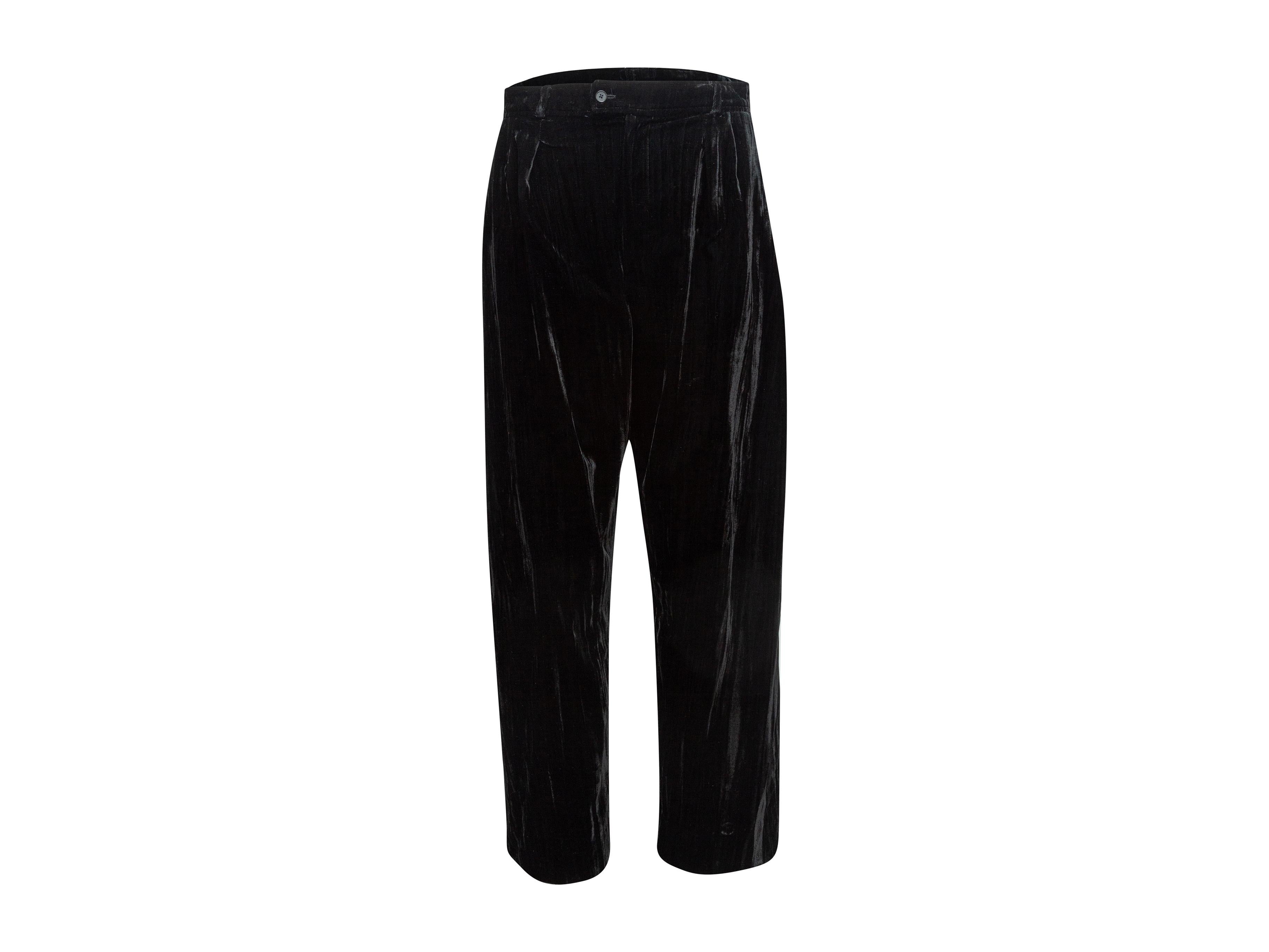 Product details: Vintage black velvet pants by Yves Saint Laurent. Circa 1990s. Dual hip pockets. Zip-fly closure. 32