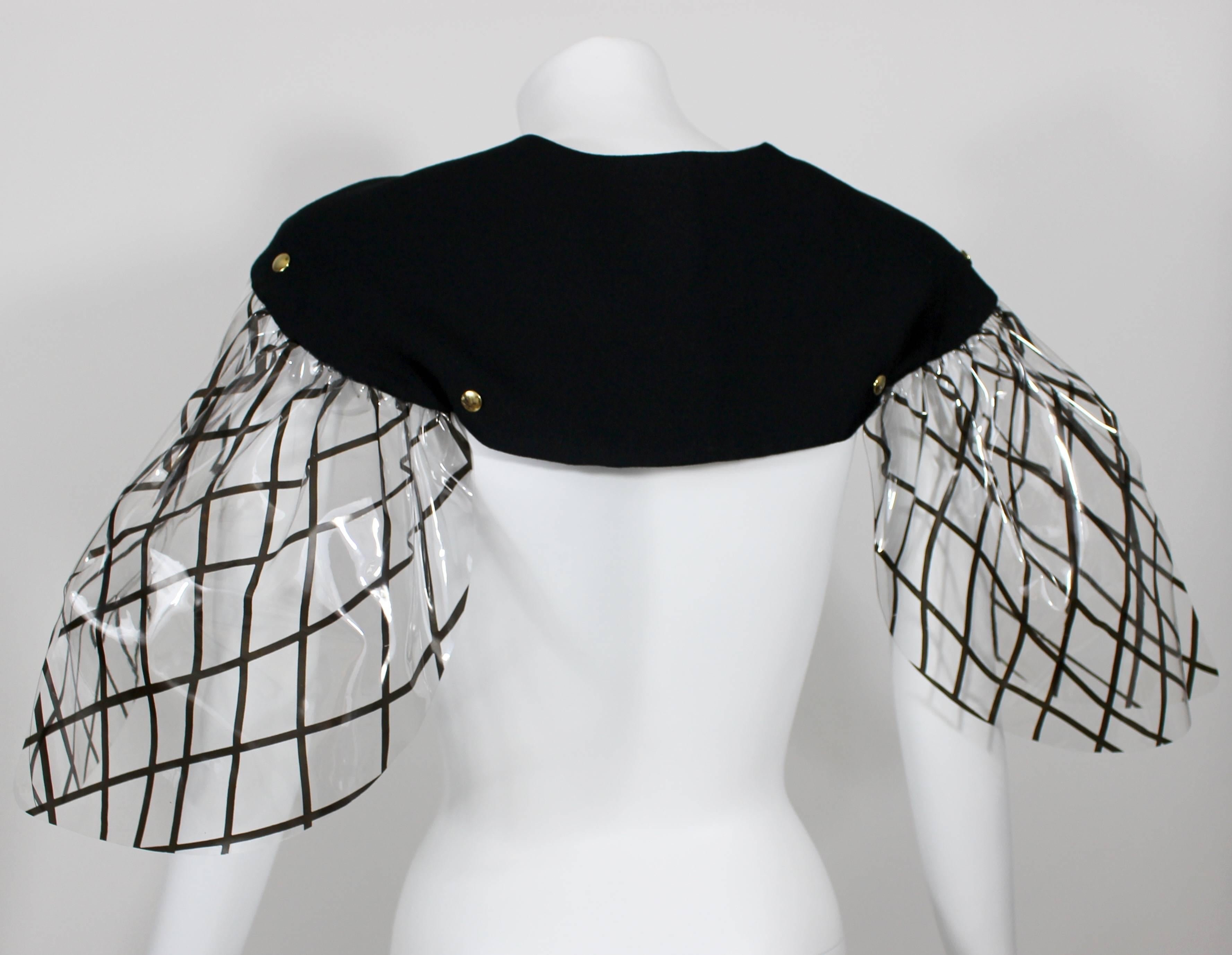 A black and clear  pvc Yves Saint Laurent capelet.
Fall 2010 collection
Gold metal snaps on the front.

Size estimate: S/M
Size 40
New with tags.
