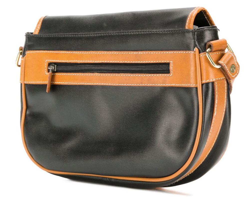 1970s black and brown Saint Laurent leather two-tone shoulder bag featuring a shoulder strap, a foldover top with magnetic closure, a front slip pocket, a main internal compartment, an internal zipped pocket and an internal logo patch. 
In good