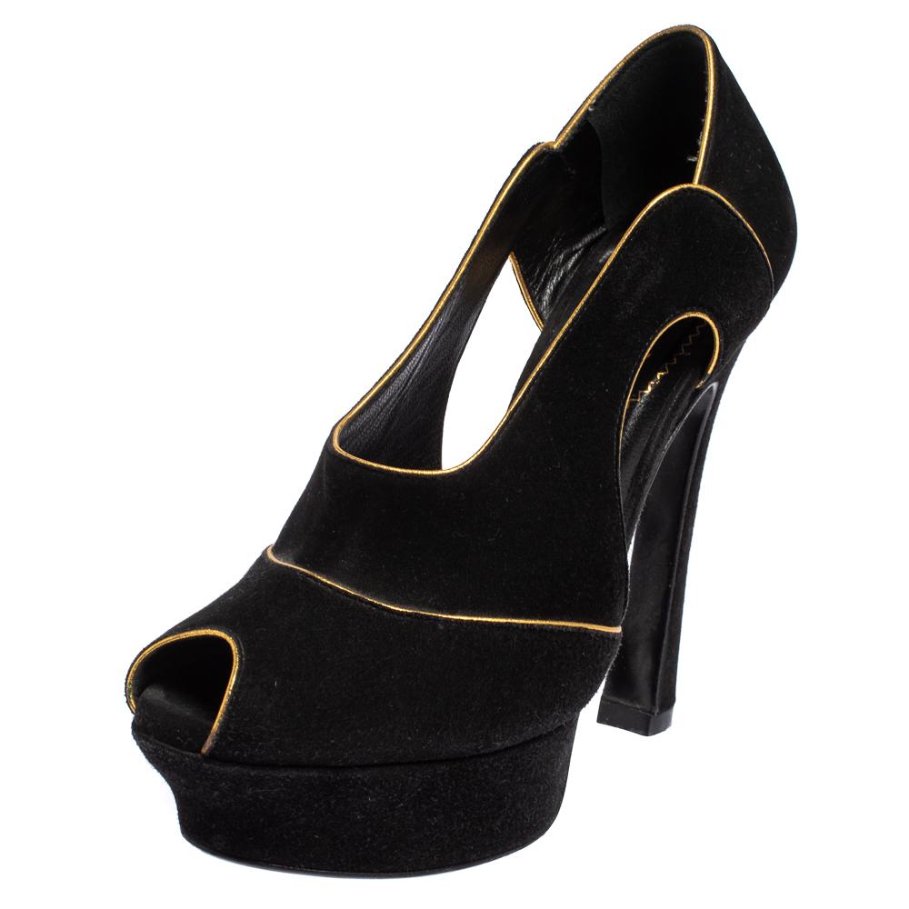 We've fallen head over heels in love with these pumps from Yves Saint Laurent! They are crafted from black suede with contrasting outlines and styled with peep toes, cut-outs revealing the skin, solid platforms, and 13.5 cm heels. Truly high