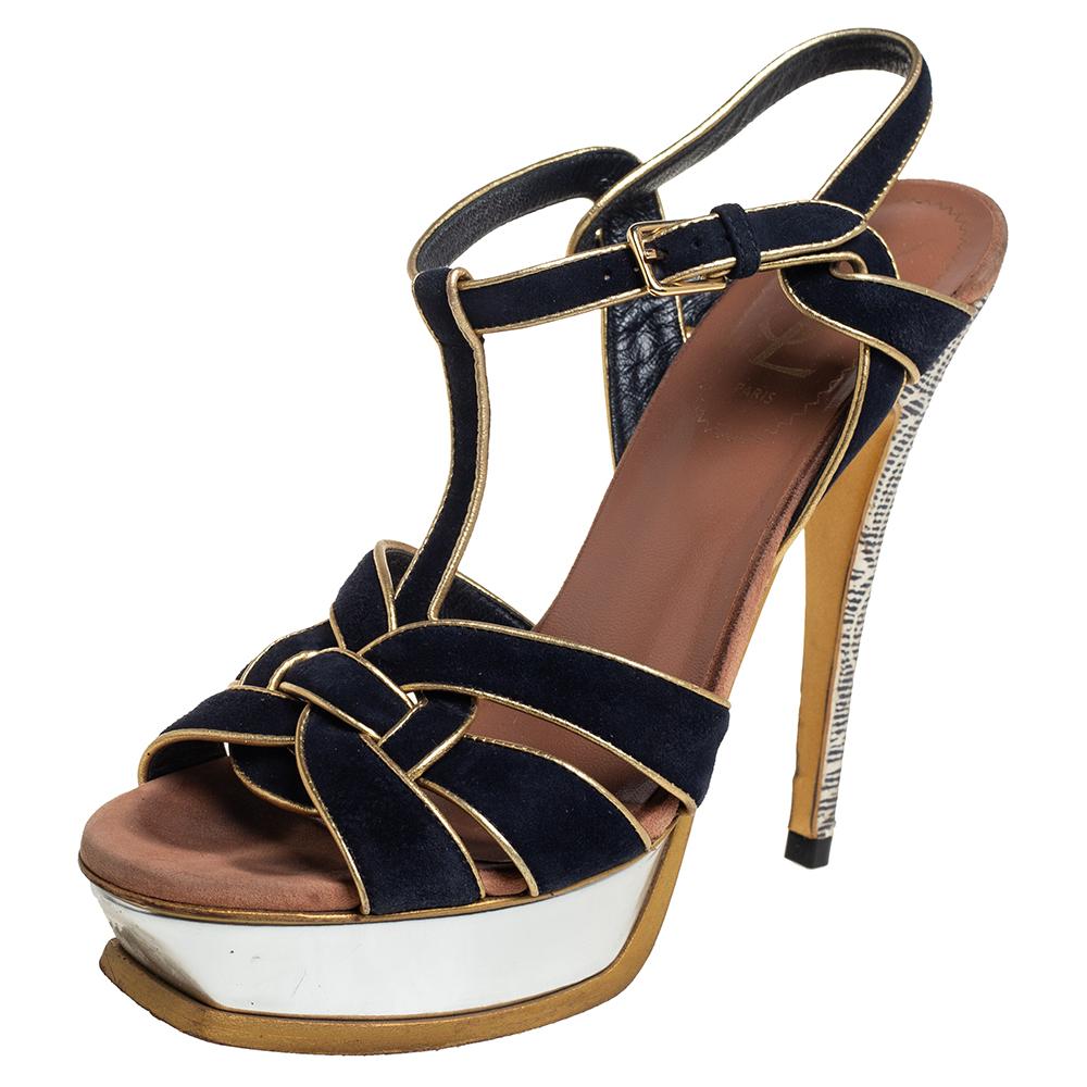 One of the most sought-after designs from Yves Saint Laurent is their Tribute sandals. They are such a craze amongst fashionistas around the world, and it is time you own one yourself. The sandals are crafted from suede in a black shade and trimmed