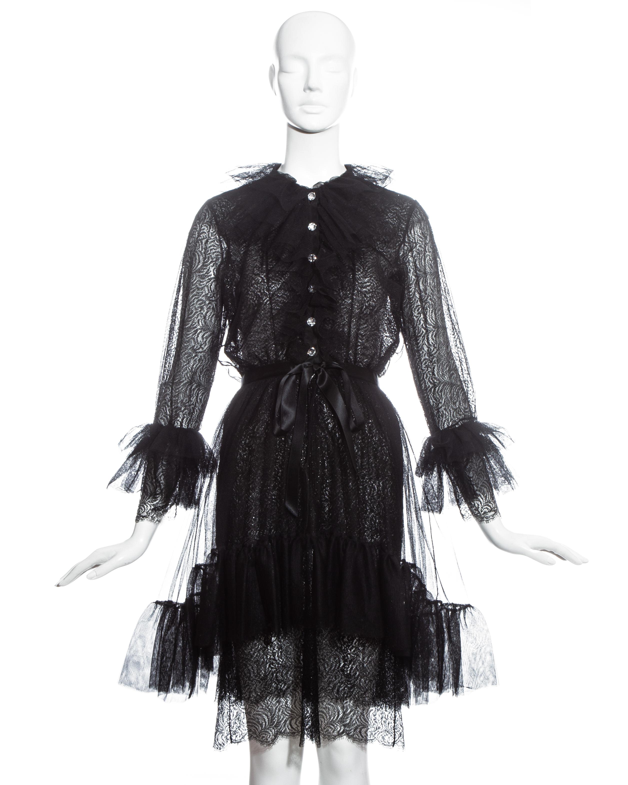 Yves Saint Laurent black lace and tulle cocktail dress with crystal buttons, detachable silk slip dress, silk bow belt and ruffled collar, skirt and cuffs.

Fall-Winter 1993