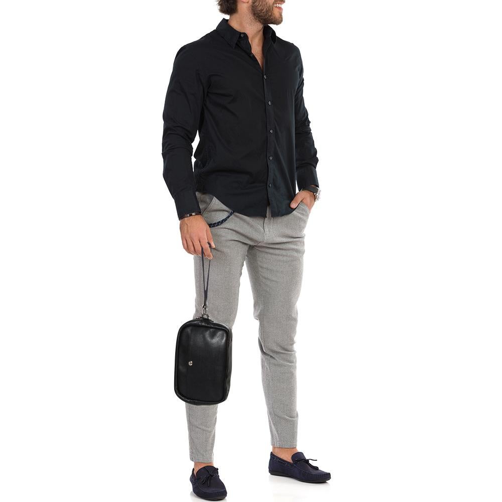 This men's pouch from Yves Saint Laurent has been made using leather in Italy. It has a fabric interior secured by a zipper on top. The handy pouch has a simple shape complete with a wristlet.

