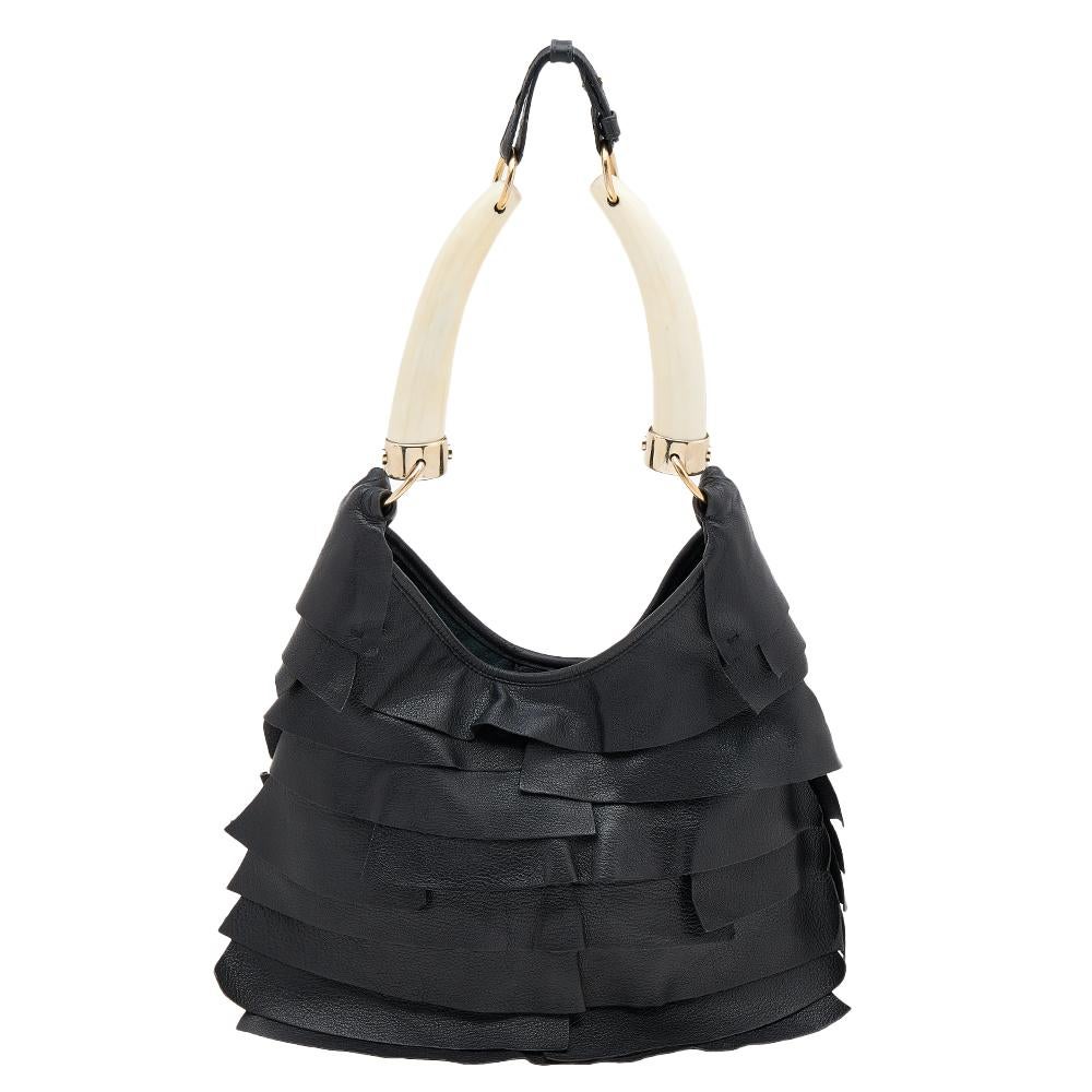 Coming from Yves Saint Laurent is this unique hobo that is a true example of high fashion and skillful craftsmanship. The black hobo has been made from leather and flaunts a horn-like handle along with gold-tone hardware. It is a great bag to carry