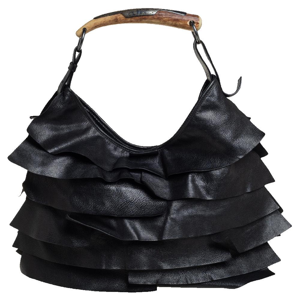 This hobo by Yves Saint Laurent has been perfectly designed to accompany you to all your fashionable outings. It is made from black leather and has gorgeous ruffles and the brand label flaunted on the front. The suede insides are spacious and the