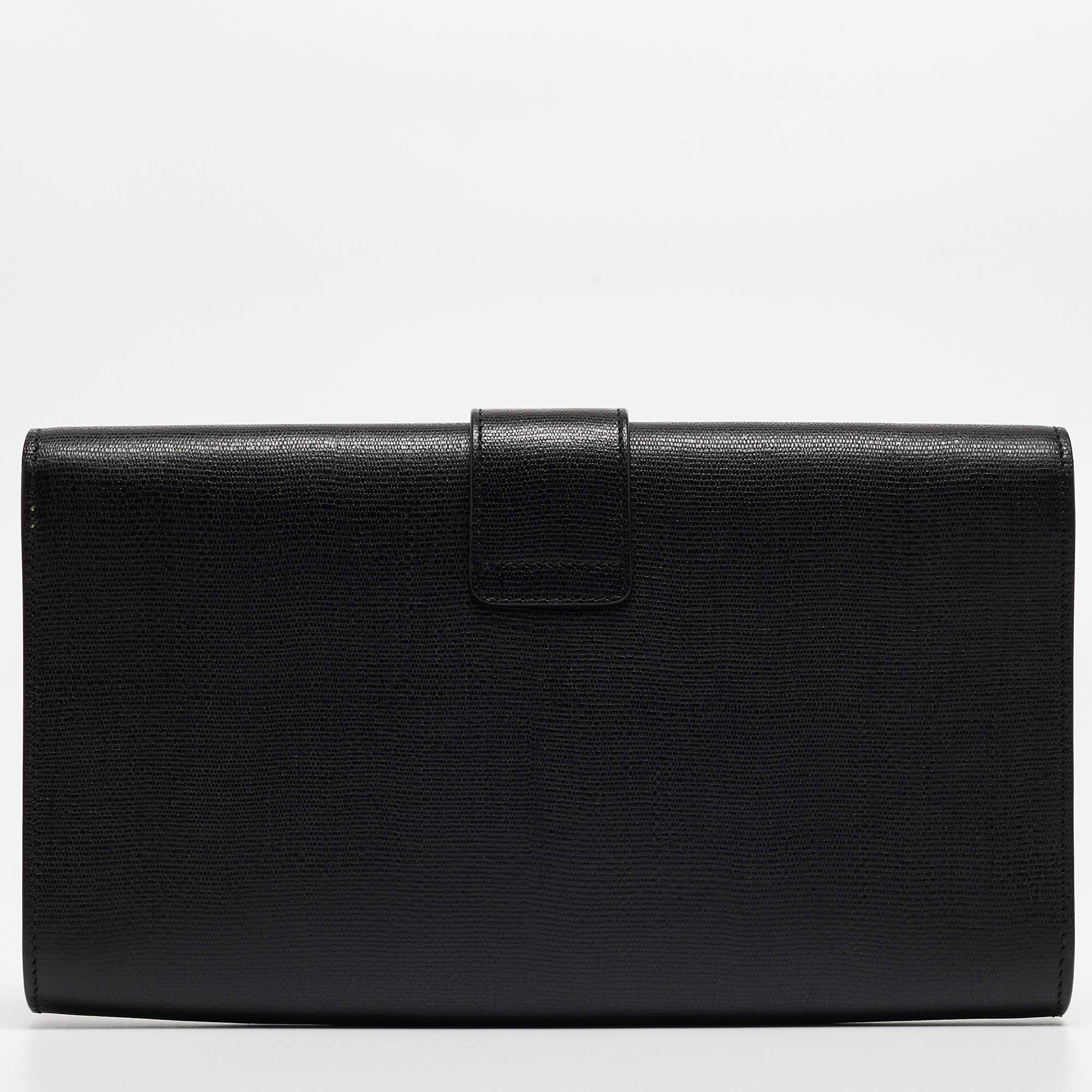 A simple design highlighted by a gold-tone Y on the front. The Y line clutch by Saint Laurent is crafted from black leather and designed in a flap style. It has a spacious satin interior where you can carry your cards, cash and other