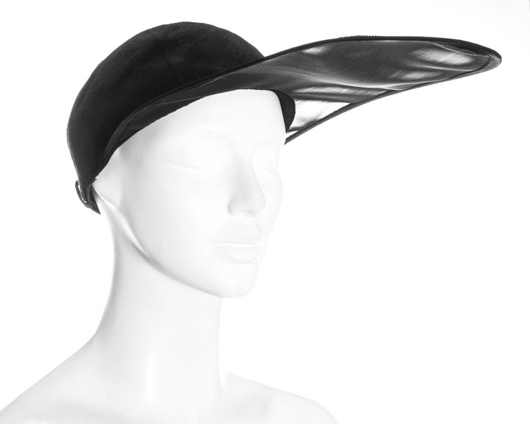 Yves Saint Laurent black linen fitted cap with extra long organza visor and buckle fastening.

Spring-Summer 1991